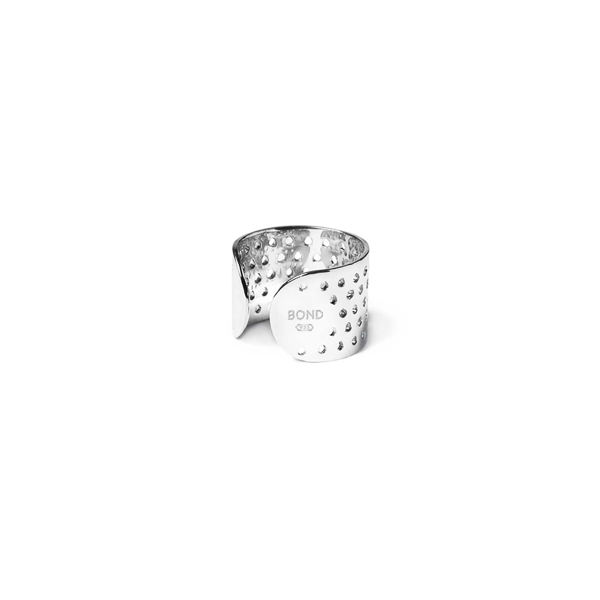 Breathable perforated ring cuff in solid, hypoallergenic 935 Silver. Wear at the base of the finger or as a mid-ring above the knuckle, alone or as part of a stack.

FEATURES
- Available in a selection of sustainable, recycled metals: 935 Silver or