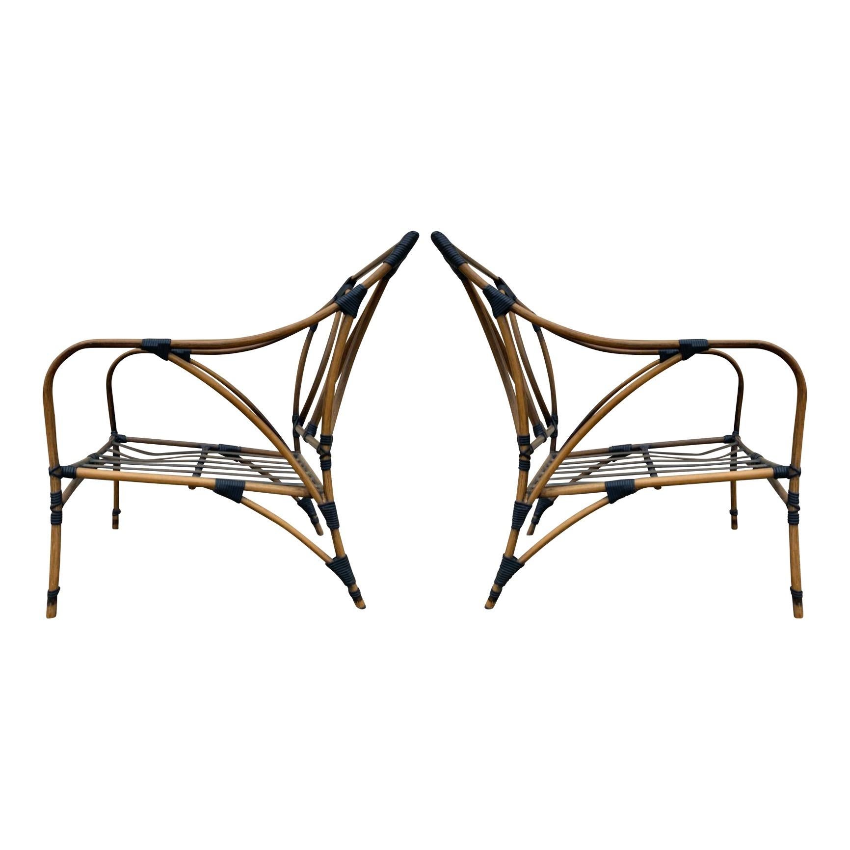 Elegant pair of metal-framed faux finished tubular aluminum lounge chairs made to look like bamboo, but far more structurally stable and long-lasting. Excellent condition with the exception of one bend to one frame and insignificant/unseen bends to