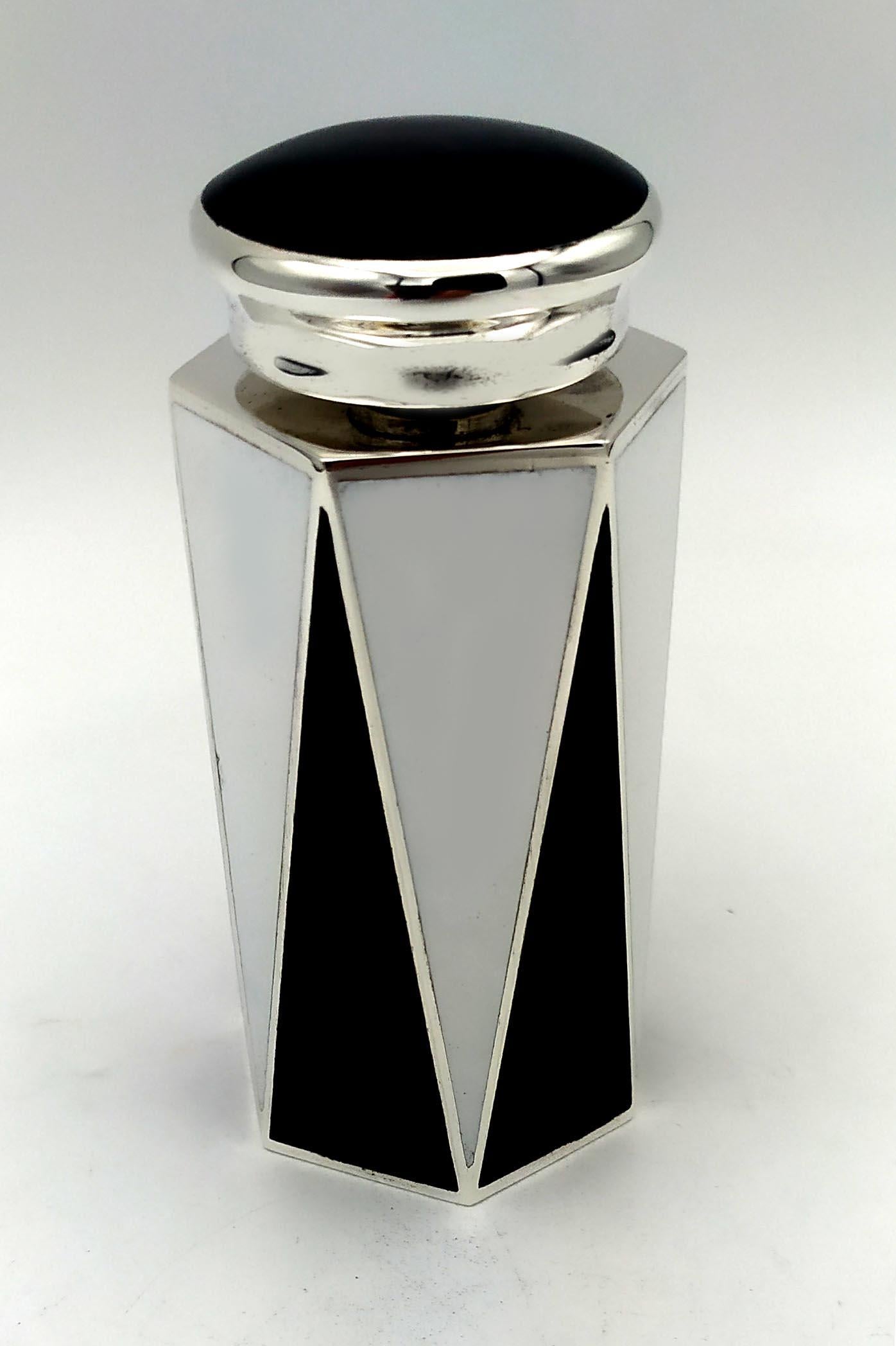 Hexagonal base perfume holder in black and white fired enamel 925/1000 sterling silver with screw cap, in Art Deco style. Base cm, 4.2 x 4.7 bottle height cm. 8, total height cm. 10.7. Silver weight gr. 187. Designed by Giorgio Salimbeni in 1981 and