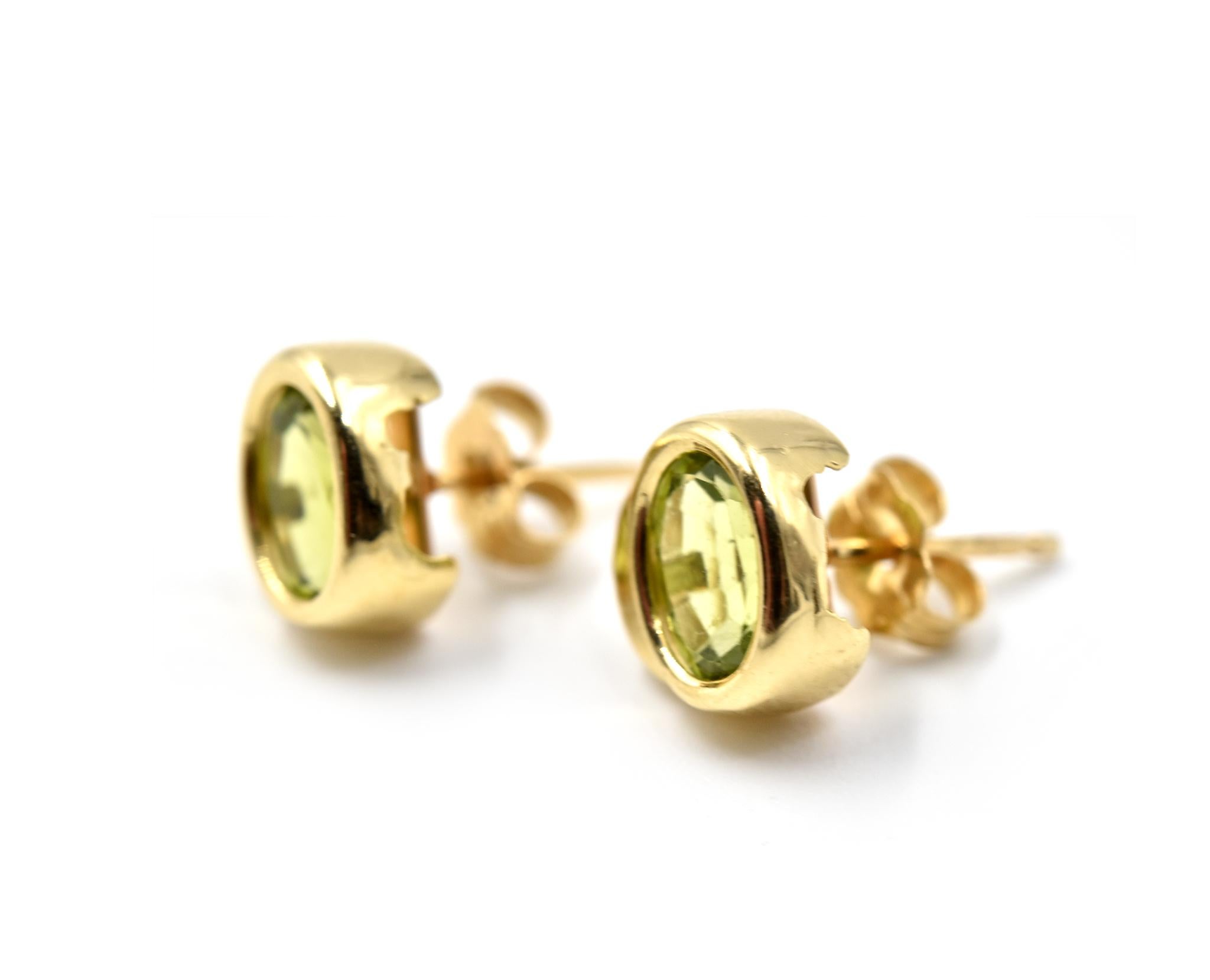Designer: custom design
Material: 14k yellow gold
Gemstone: two oval cut peridot gemstones
Fastenings: friction backs
Weight: 2.03 grams
