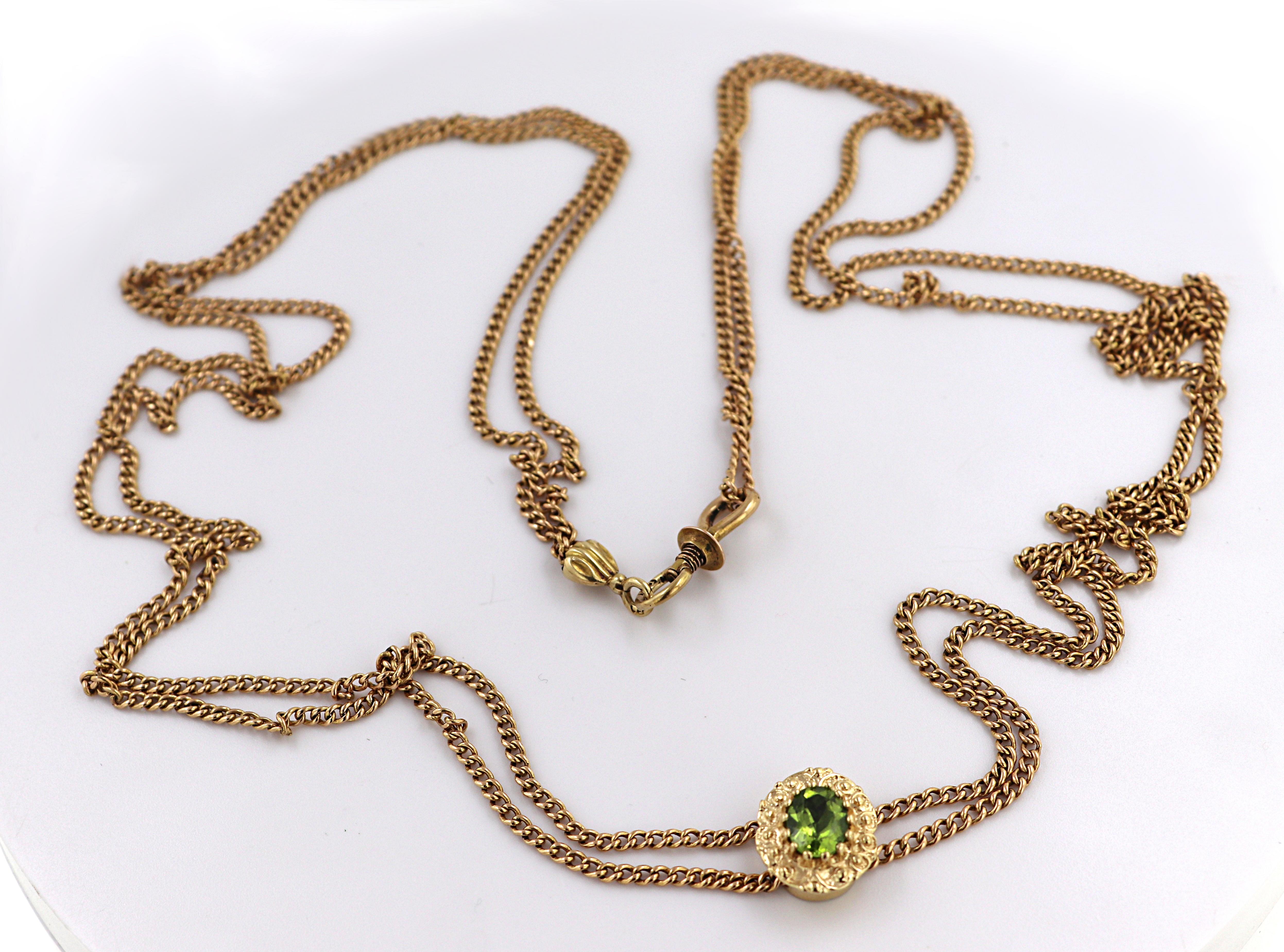 Featuring (1) oval peridot, 1.25 ct., set in a 14k yellow gold Victorian style oval slide, 14 X 11 X 6.6 mm,
suspended from a 2 X .9 mm, flat curb link chain, completed by a screw locking hinged hook clasp,
forming a 66-inch necklace, Gross weight