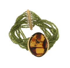 Pulsera artesanal de oro amarillo de 18 quilates con peridoto y ámbar