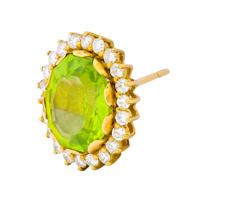 Each centering a step cut, decagon shaped peridot measuring approximately 12.0 x 9.0 mm, approximately 7.0 carat weight total, bright lime green and very well matched

Within a prong set round brilliant diamond surround, weighing approximately 0.90