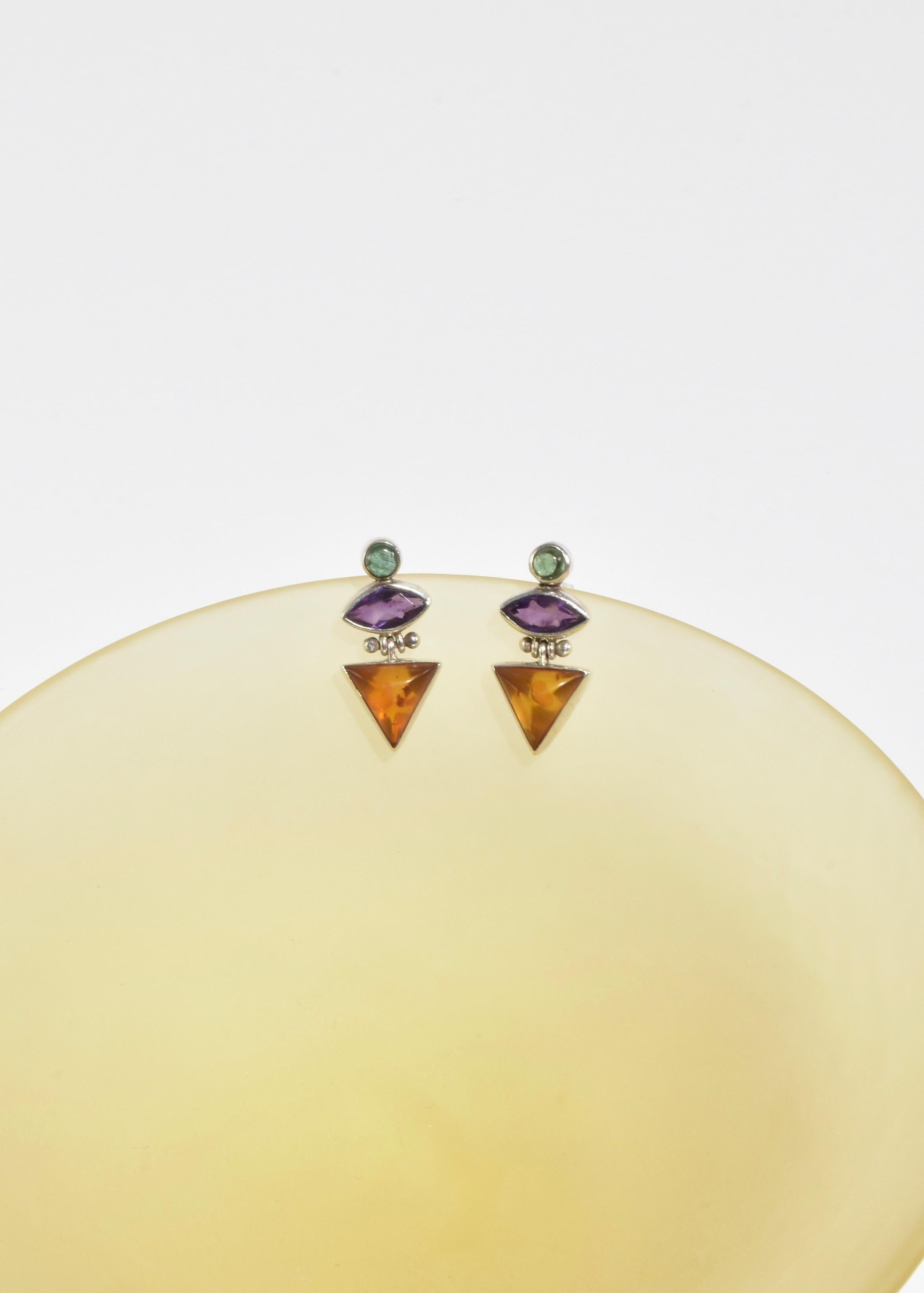 Vintage silver earrings with geometric amber, amethyst, and peridot stones, pierced. Stamped 925.

Material: Sterling silver, amber, amethyst, peridot.