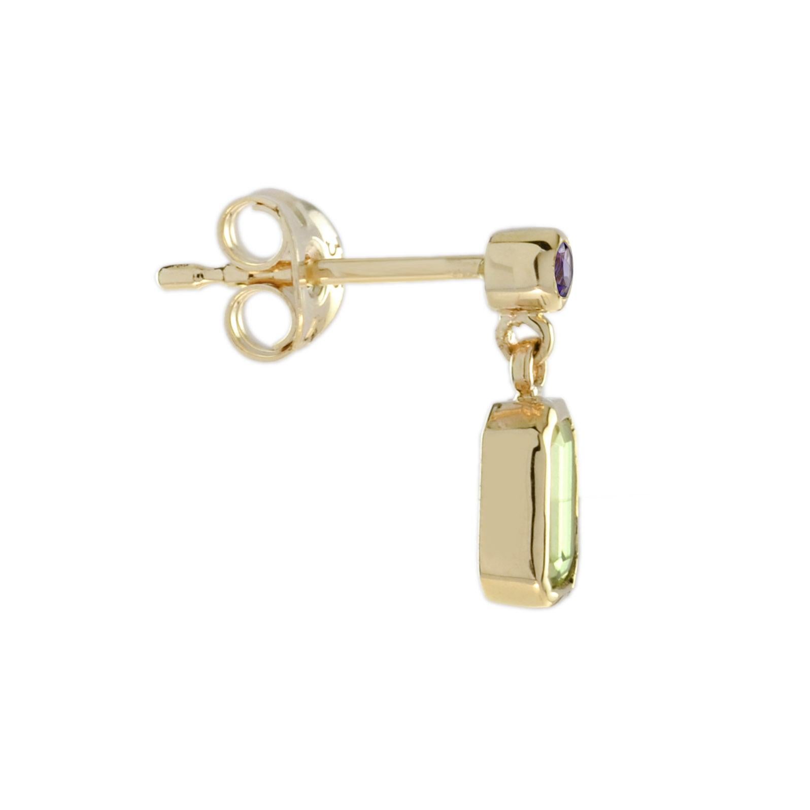 A lovely pair of 1.20-carat emerald cut peridots suspended from two pearls set in 14k yellow gold. An effortless upgrade to your accessary wardrobe. 

Earrings Information
Style: Vintage
Metal: 14K Yellow Gold
Width: 4.5 mm.
Length: 12 mm.
Total