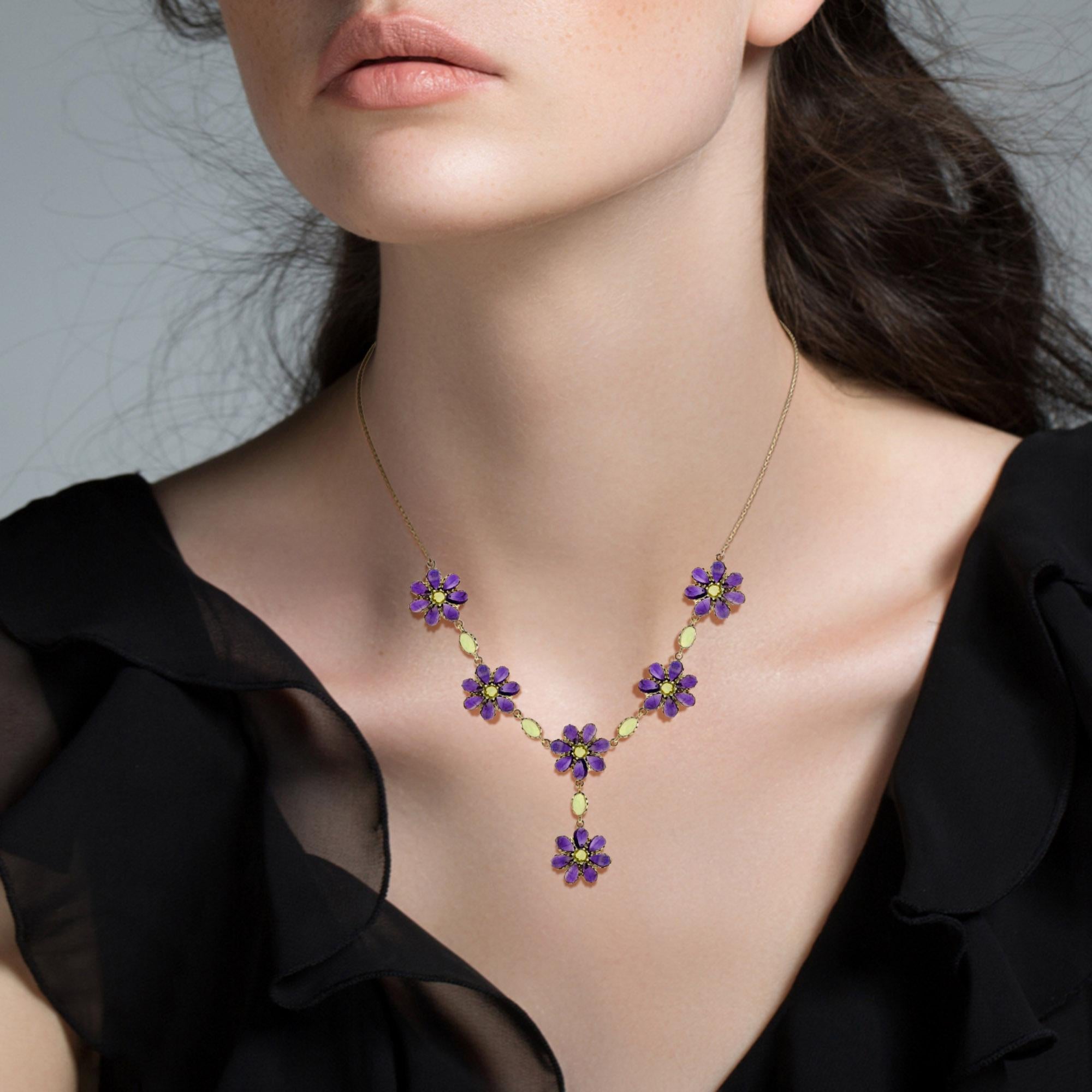An extraordinary antique Victorian style lavaliere necklace showcasing a fabulous floral design pendant decorated with an array of colorful natural amethyst and peridot. It is a truly magnificent piece and boasts some of the finest natural