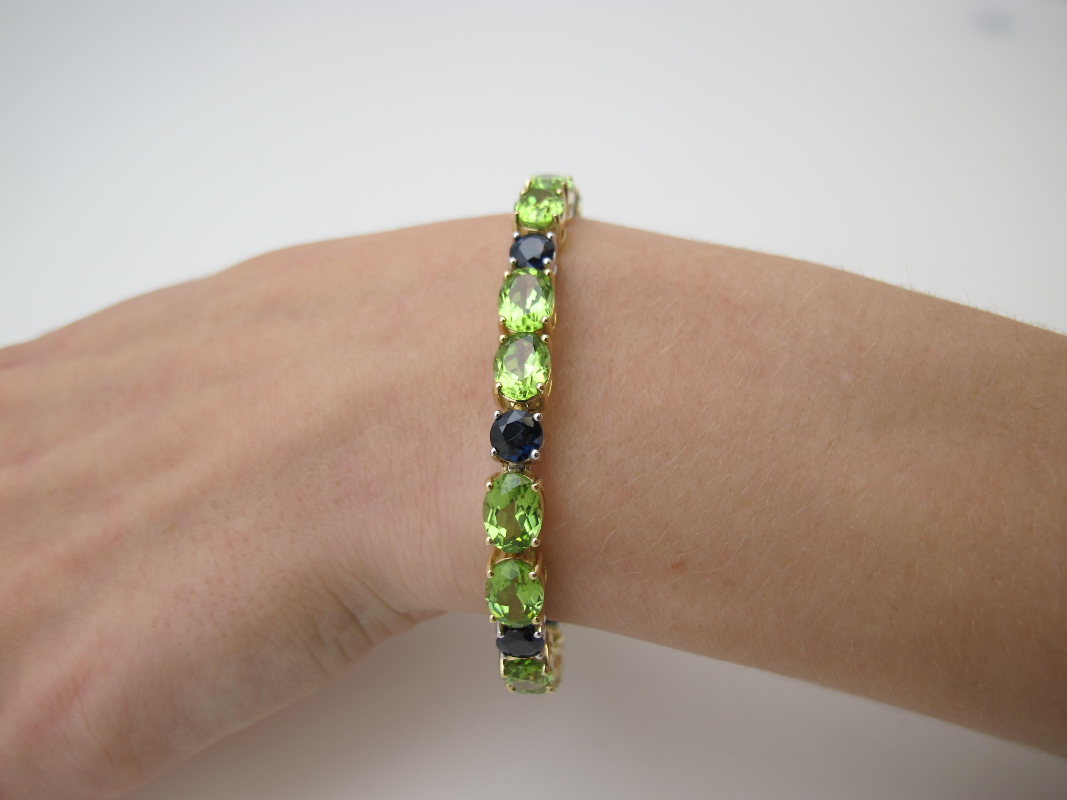 This modern take on the classic tennis bracelet features bright green peridots and rich blue sapphires set in a combination of 18k yellow and white gold. The sparkling oval peridots have been set in yellow gold to complement their bright, sunny hue,