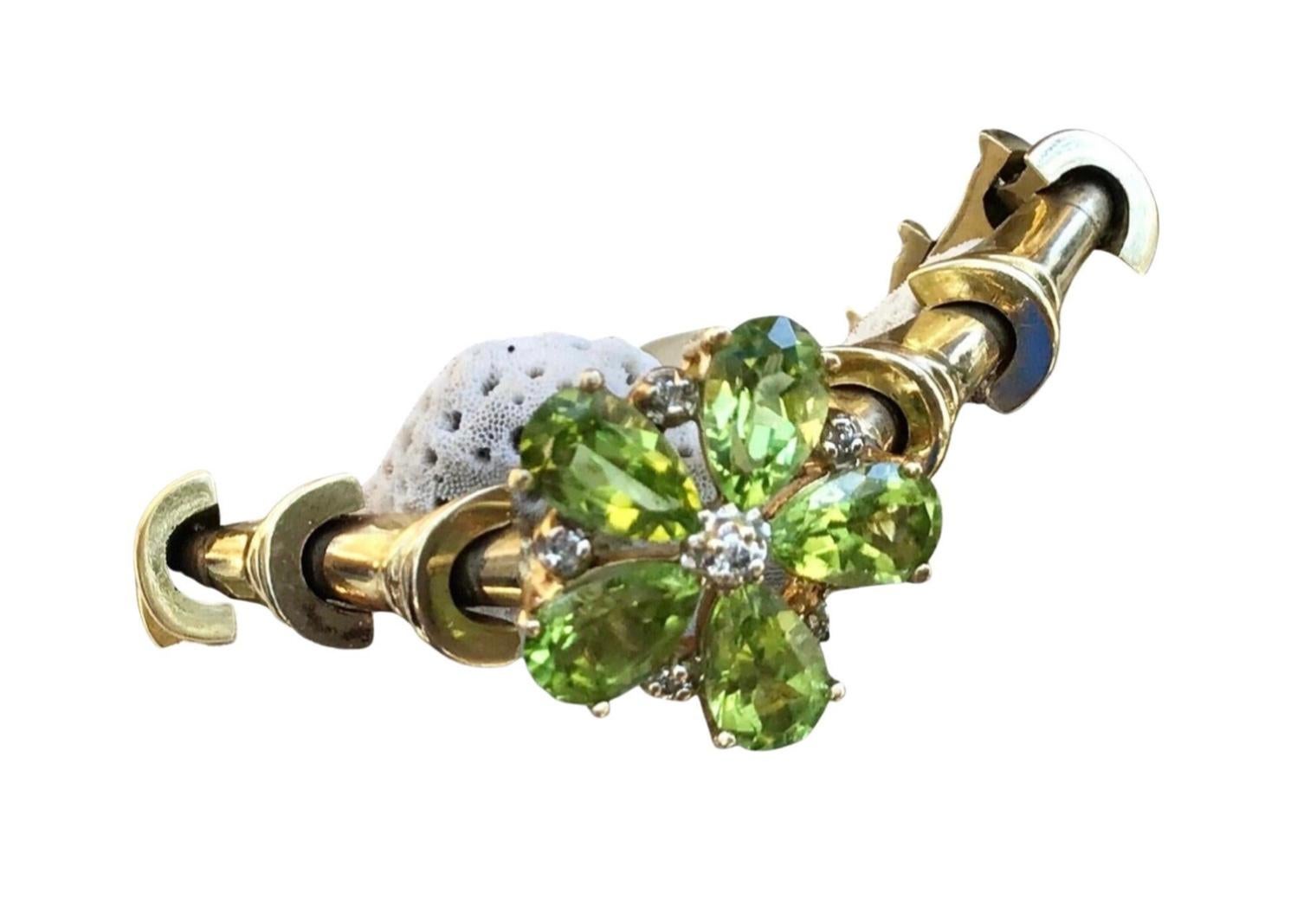 Stunning 14k yellow gold Peridot and Diamond Bracelet.  17.66 Grams TW. Each of the five peridot stones are approximately 0.5 carats for a total of 2.5 total carats. Marked 14k. Approximate diameter of bracelet is 6.5 inches 