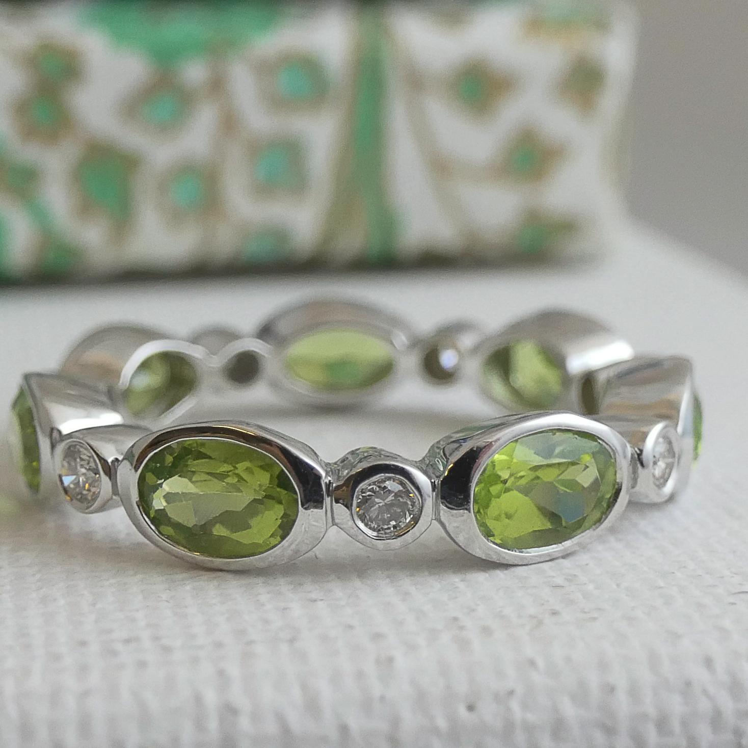 4x6mm faceted oval peridot and small diamonds are bezel set in 14kt white gold. Total diamond weight is 0,24 and they are of color H and clarity SI.
Ring Size 9

  