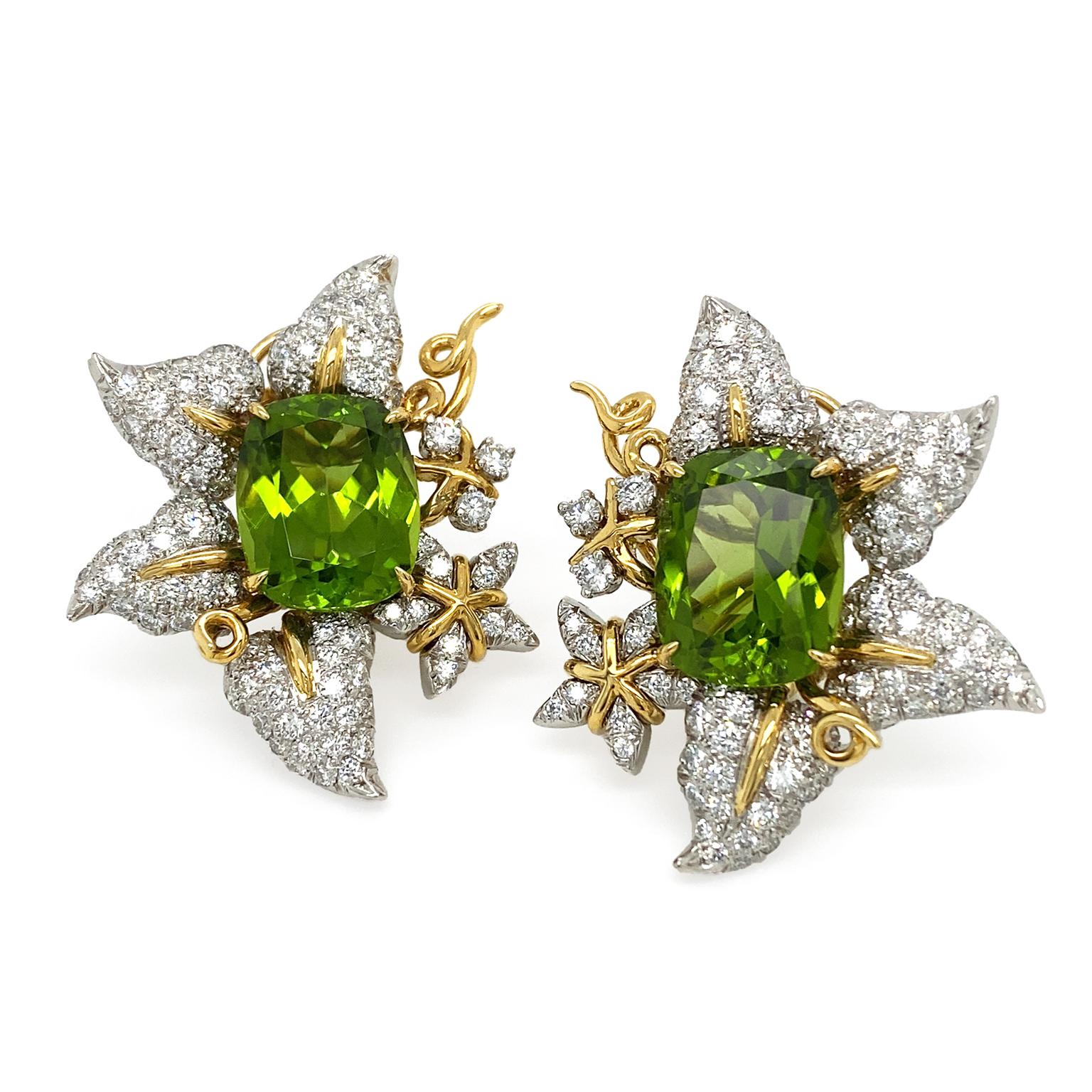 Peridots glimmer an array of light and forest green hues as the center of these earrings. Surrounding the jewel are platinum leaves, which are embellished with brilliant cut diamonds. 18k yellow gold serves as the midrib of the leaves as well as