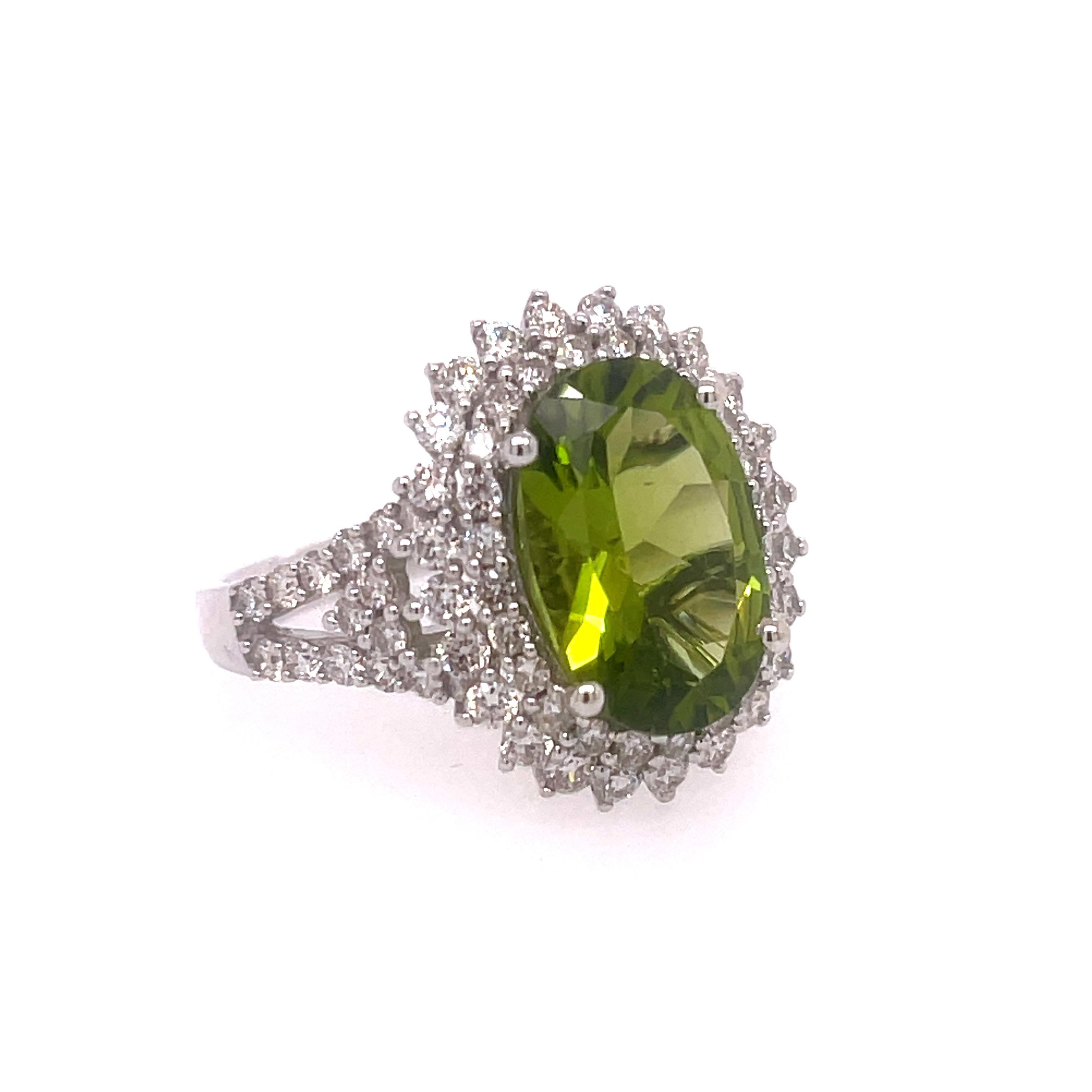 Peridot and Diamond Ring in 14K White Gold.  Peridot is 4.23ct and Diamonds are 1.26.  Size 7.5.  Super shiny faceted Peridot sparkles to the moon and back.  Total weight is 5.2 Grams.  Stamped JH 14K PD4.23CT.