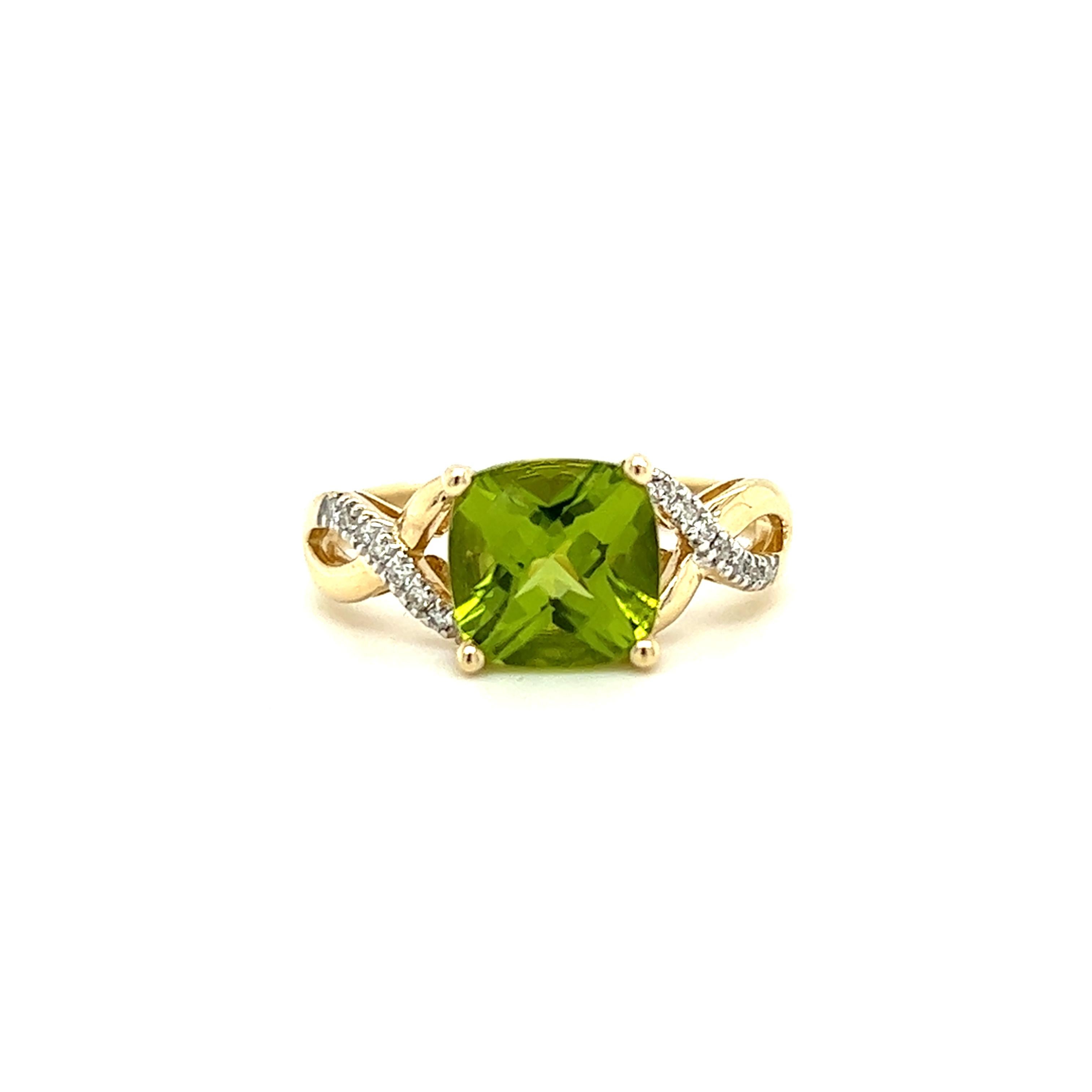 One 14-karat yellow gold ring set with one (1) 8m cushion cut green peridot, and fourteen (14) brilliant cut diamonds, approximately 0.10-carat total weight with matching H/I color and SI1 clarity. The ring is a finger size 7 and can be resized. 
