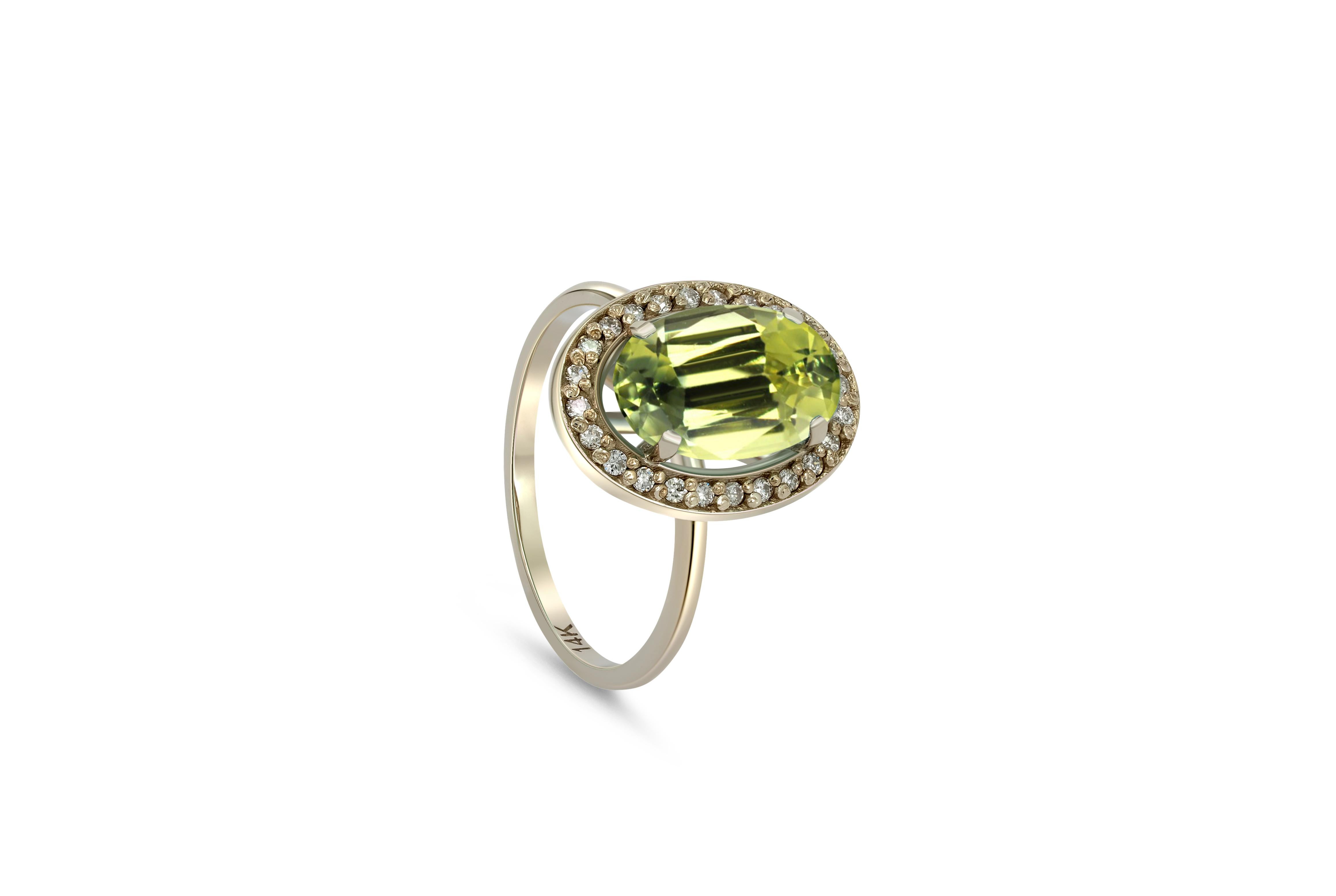 Modern Peridot and diamonds 14k gold ring.  For Sale