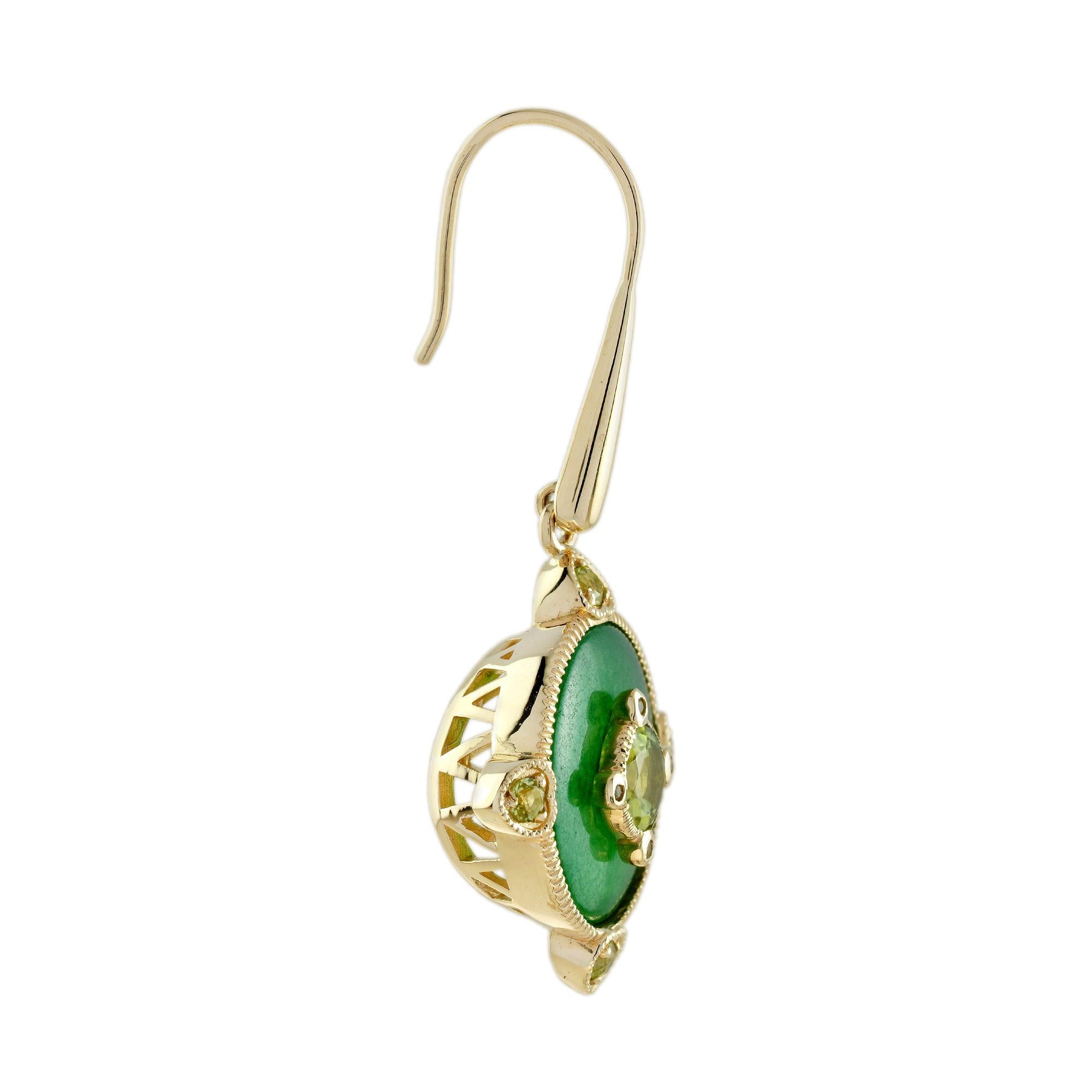 This elegant antique style pair of peridot and jade drop earrings in 14k yellow gold features a smooth oval shape jade with the a peridot in bezel set at its center. Additional peridots were added for more charming overall look. Very versatile, can