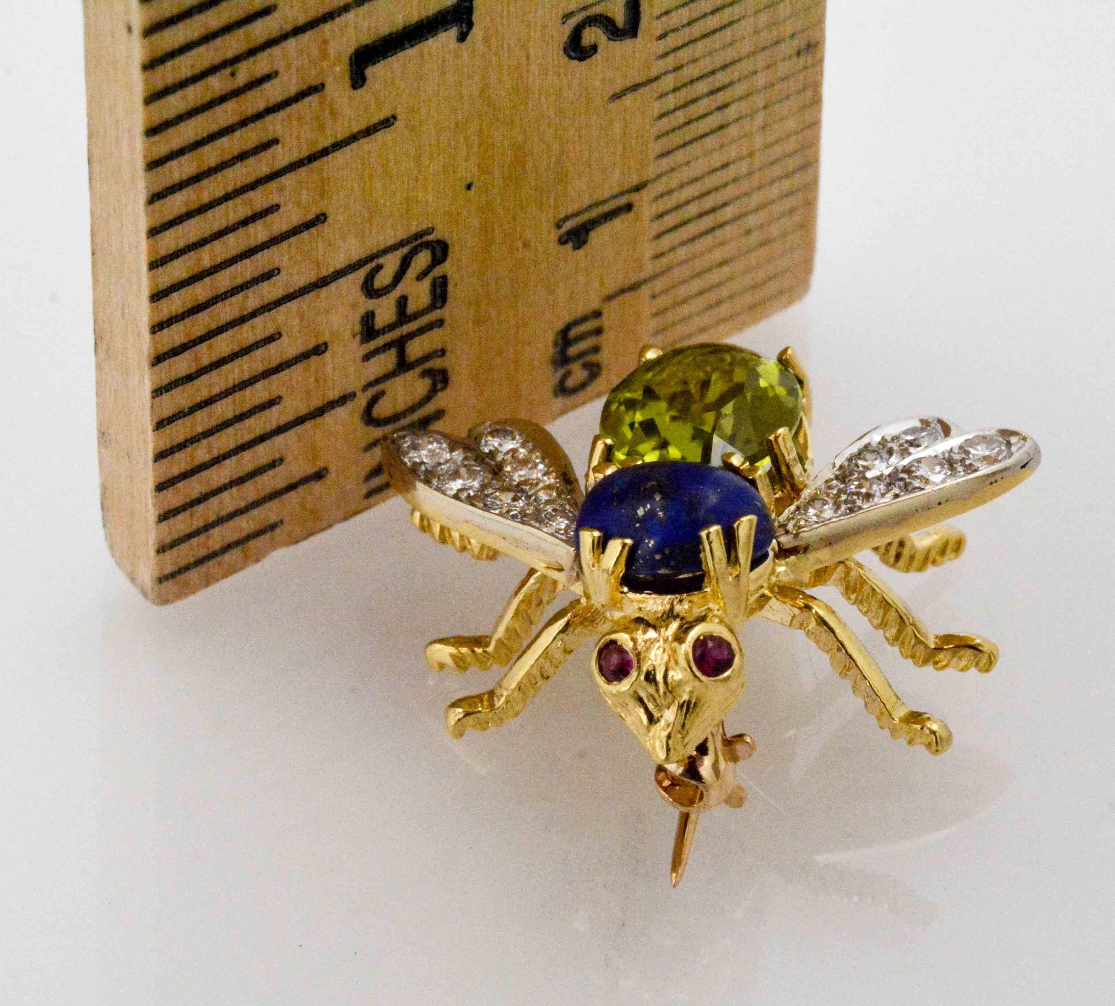 Ready to land on your lapel is this expertly handcrafted 14 Karat yellow gold Herbert Rosenthal Bee pin. This adorable modern style 1960's bee brooch has an oval blue lapis and 1.89 carat oval green peridot body, round ruby eyes and pave set diamond