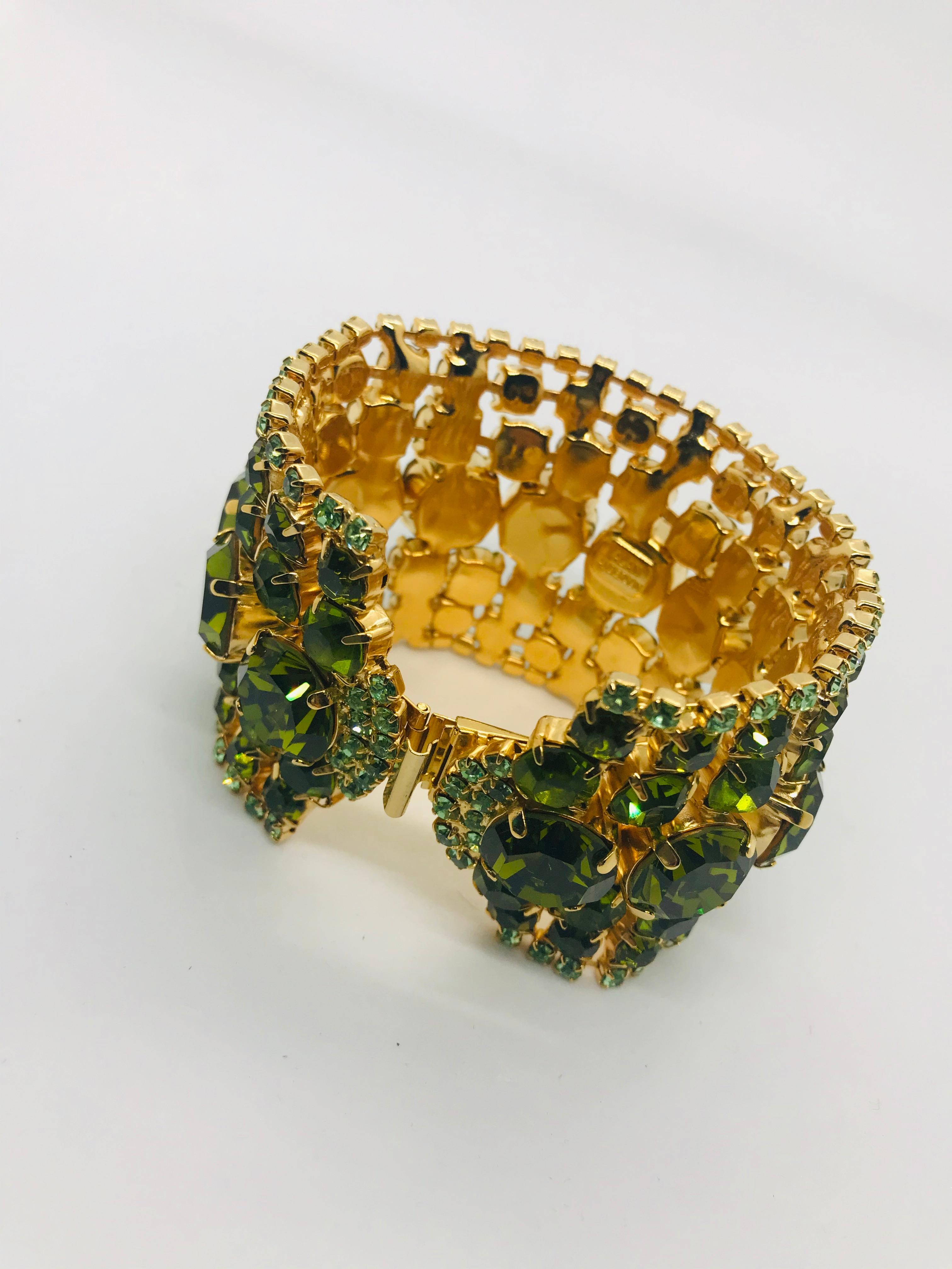 This peridot and olivine Austrian crystal flex cuff bracelet has a strong and intense pop of colour. It's architectural lines feature graduating rows of 1950s vintage Swarovski olivine crystal stones.  This bracelet is plated in 14k gold and fits