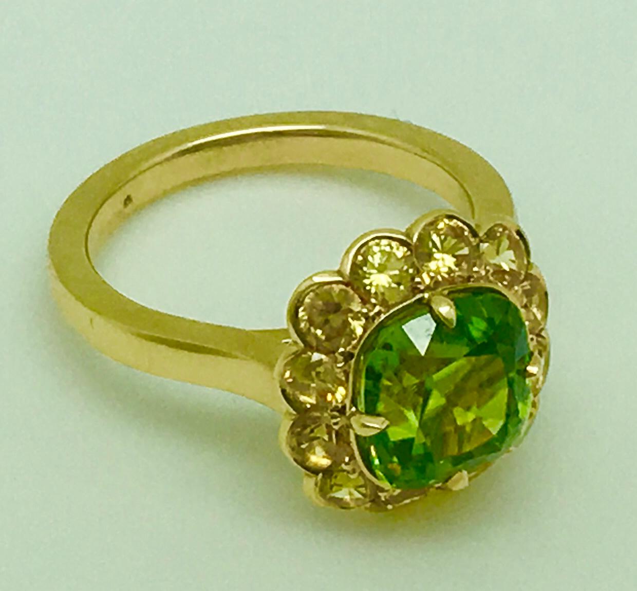 Peridot & Yellow Sapphires in a custom handcrafted 18KT Yellow Gold hand built mounting.
The Peridot is 3.16 Carats (scale weight)
The Peridot: Hue; Green with very slight yellow undertone,
Intensity: Vivid, Tone: Medium. Make is very good.
There