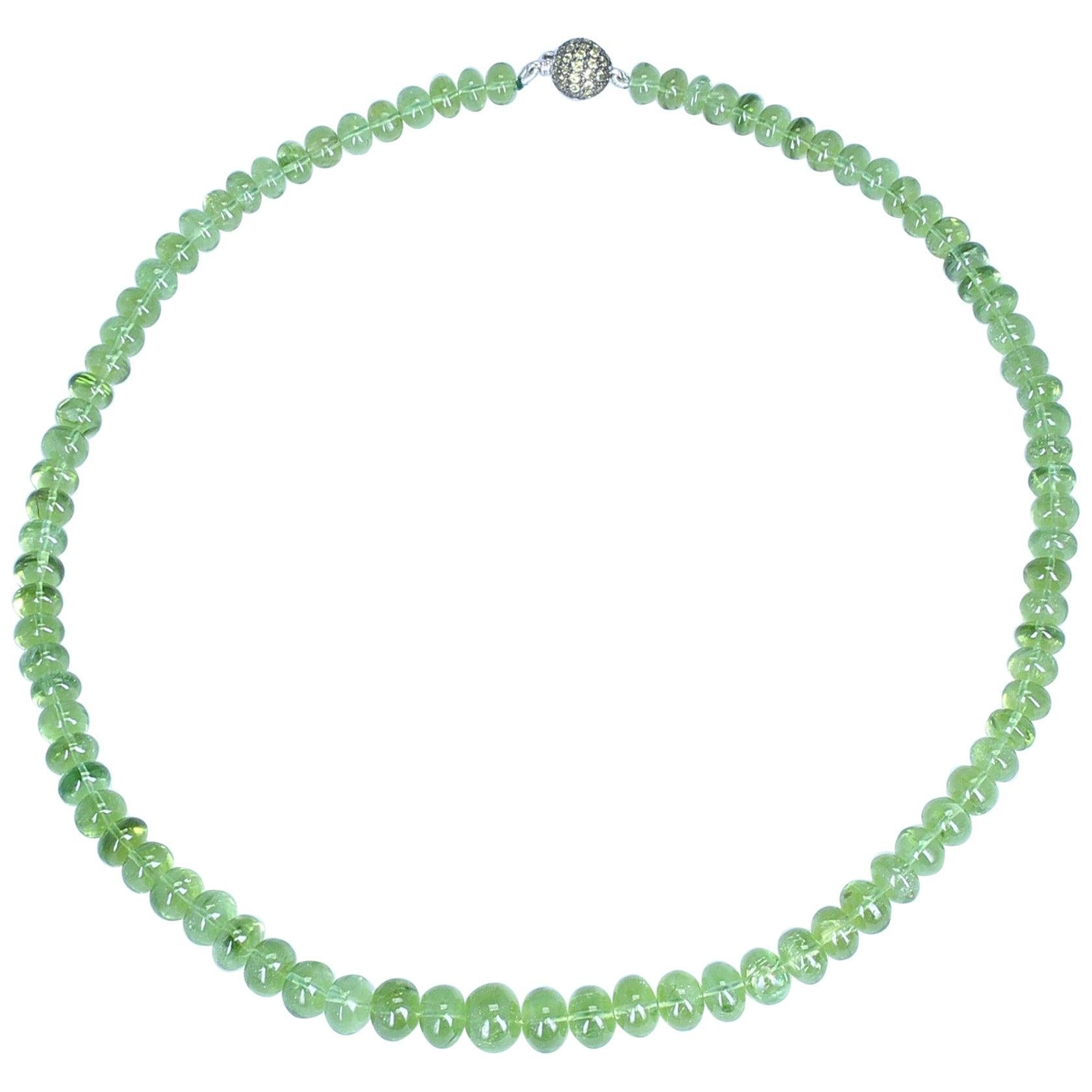 A classic necklace of green Peridot Beads with a Pave setting Tsavorite Clasp, 18K White Gold. Weight: 259.78 cts. Length: 18 inches