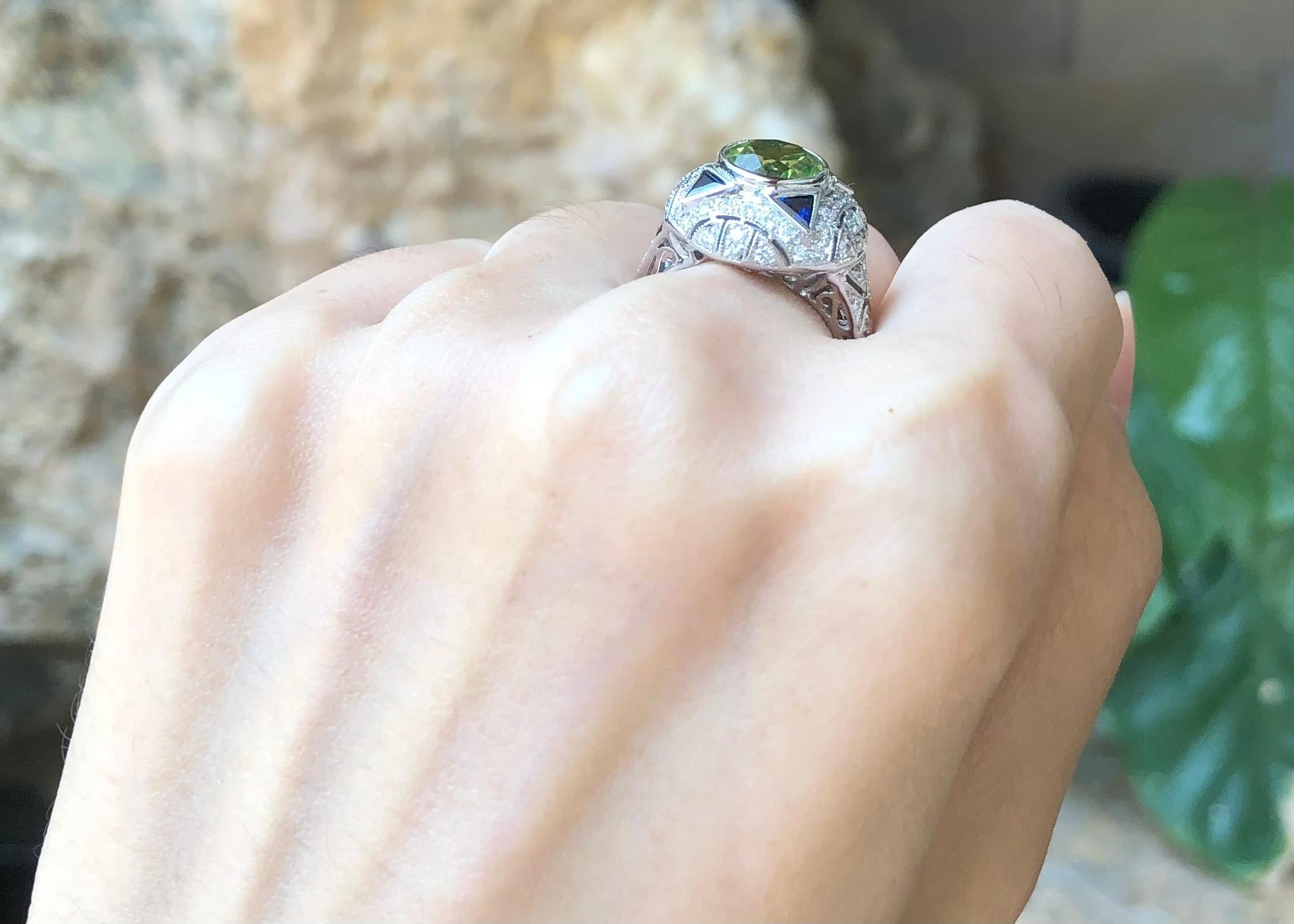 Peridot 1.73 carats, Blue Sapphire 0.60 carat and Diamond 0.49 carat Ring set in 18 Karat White Gold Settings

Width:  1.5 cm 
Length: 1.5 cm
Ring Size: 55
Total Weight: 7.03 grams



