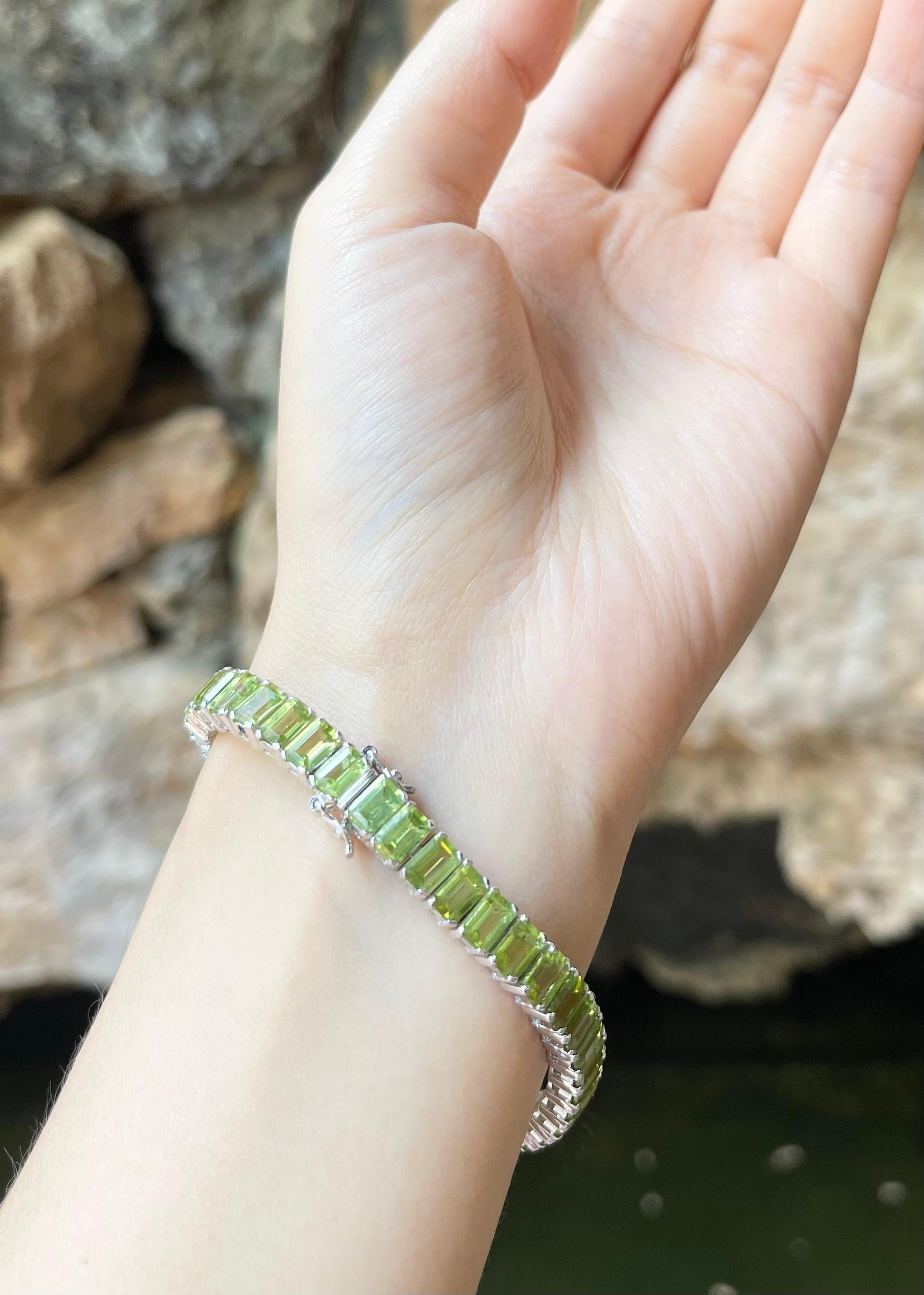 Contemporary Peridot Bracelet set in 14K White Gold Settings For Sale