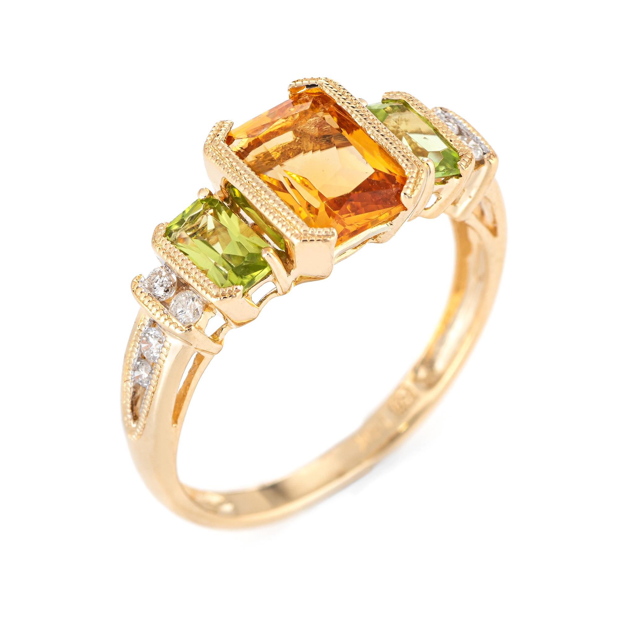 Stylish mixed gemstone ring set with peridot, citrine & diamonds in 14 karat yellow gold. 

Citrine measures 8mm x 5mm and is estimated at 1.25 carats. Peridot is estimated at 0.30 carats each (0.60 carats total estimated weight). The diamonds total