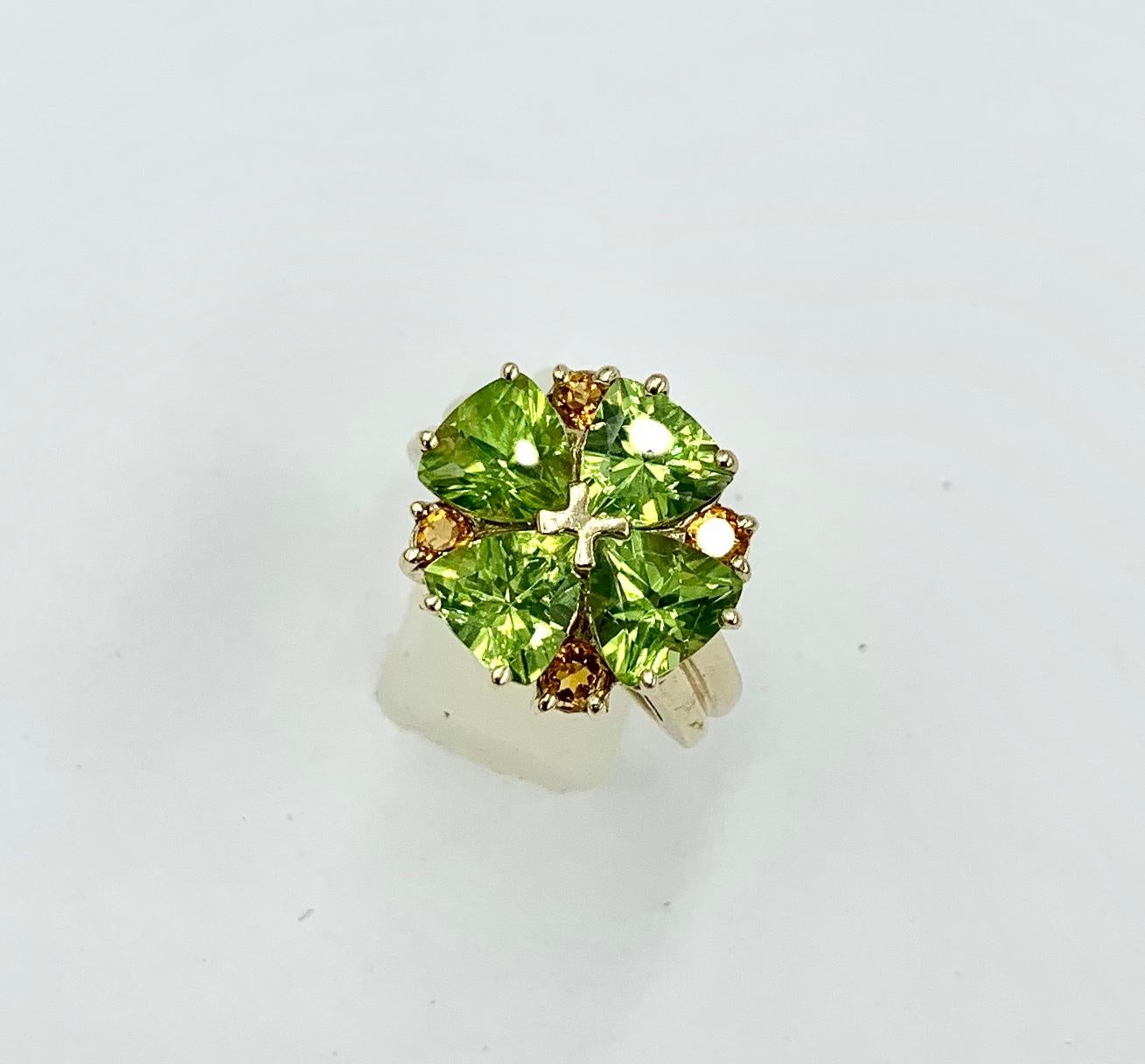 A stunning Ring set with four heart shaped Peridot gems of great beauty.  The Peridot Hearts are accented by four round Citrine gems in this sparkling and joyful Retro Ring in 14 Karat Yellow Gold.  From the collection of one of New York's favorite