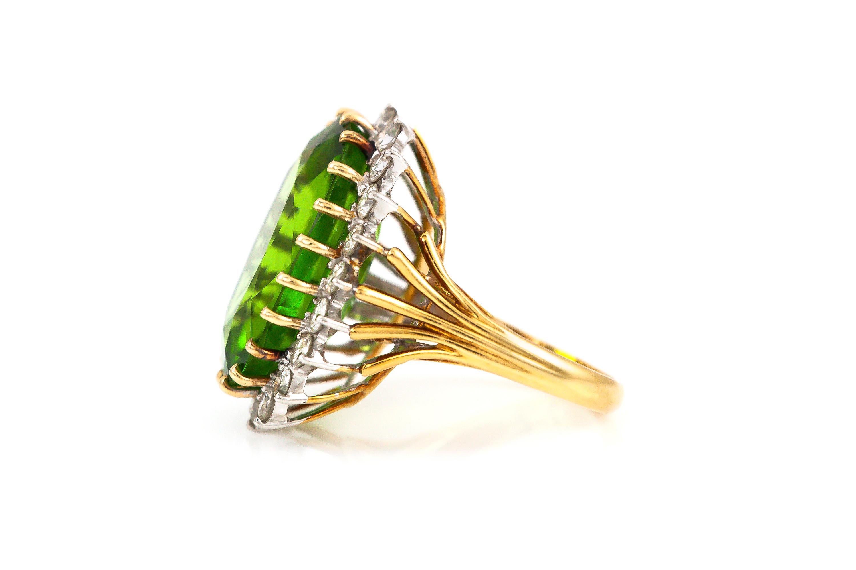 Finely crafted in 18k yellow and white gold with an Oval cut Peridot weighing approximately 12.00 carats.
The center stone is flanked by Round brilliant cut diamonds weighing approximately a total of 1.00 carats.
Size 6 1/2, resizable
