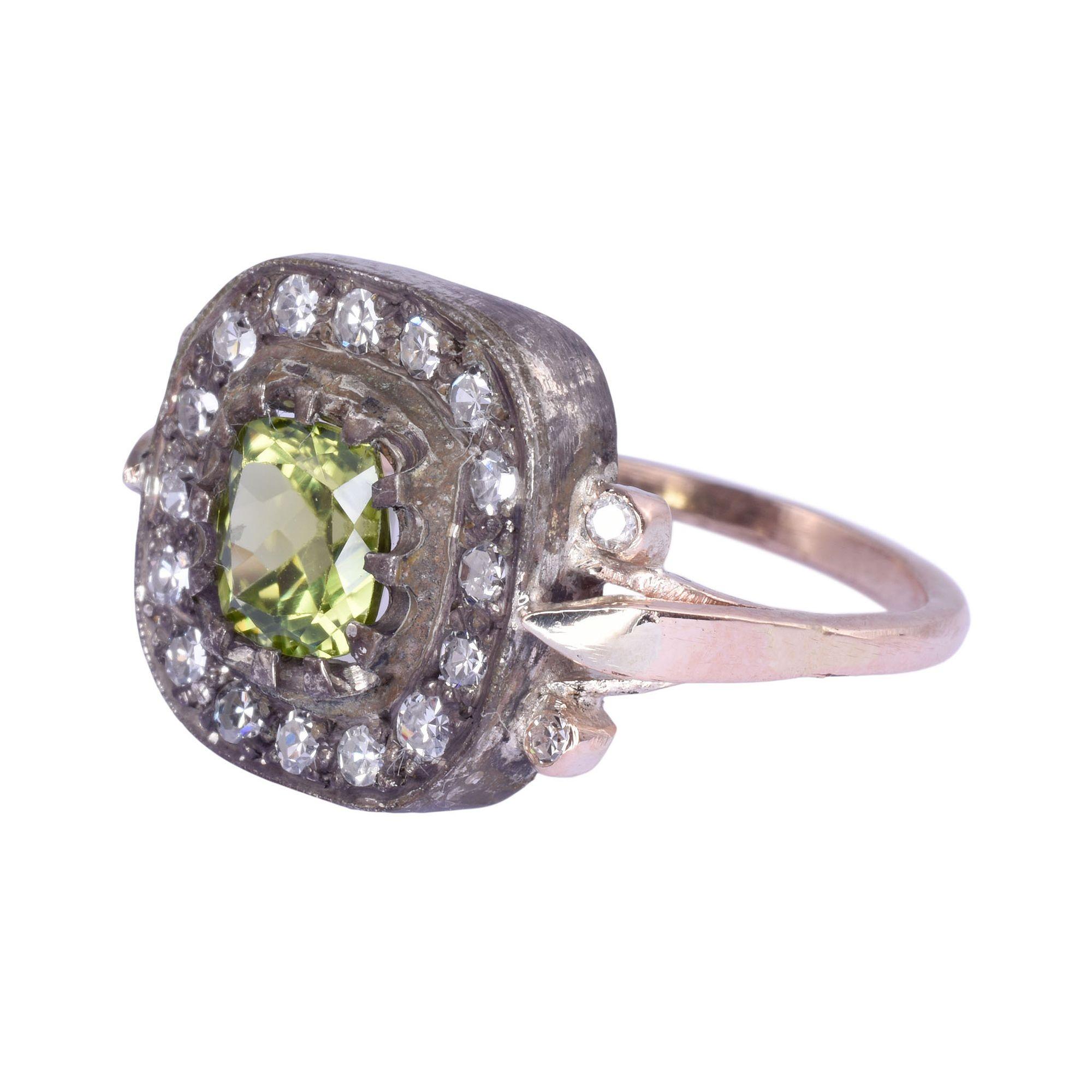 Vintage peridot diamond 14K & sterling silver ring. This vintage ring is crafted in 14 karat yellow gold and sterling silver. It features a 1.05 carat peridot center accented with .46 carat total weight of single cut diamonds. The diamond have VS