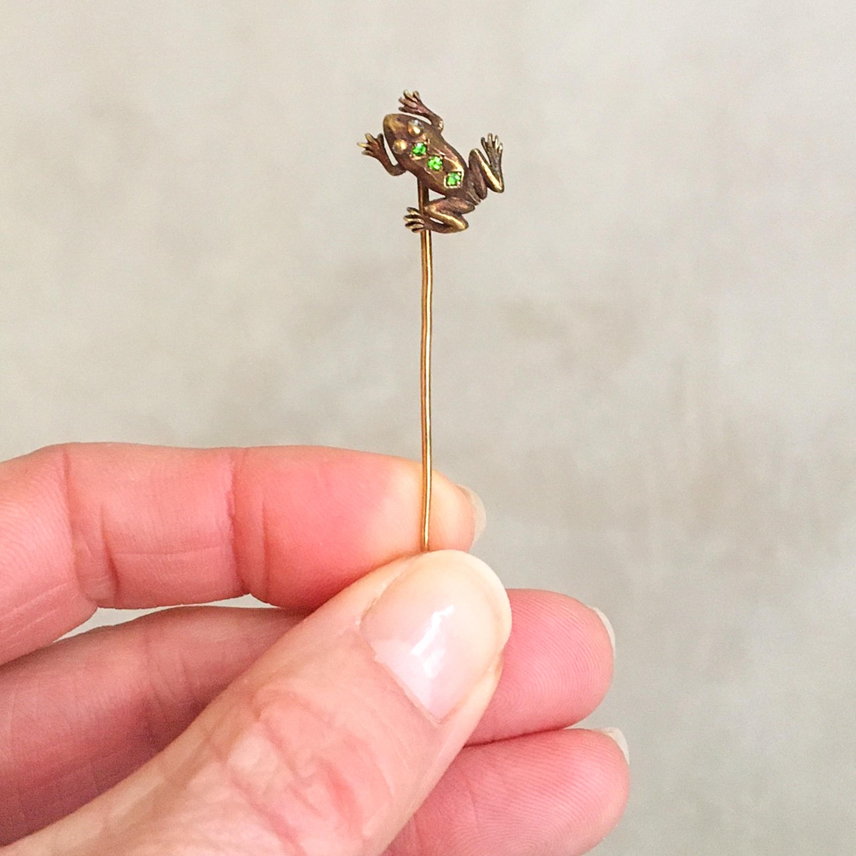 This antique Edwardian cute little frog stickpin or lapel pin is created with green peridot and bright diamond eyes. The lifelike frog is made of 14 karat gold and set with three very clear and bright green peridot stones on his back. His eyes are