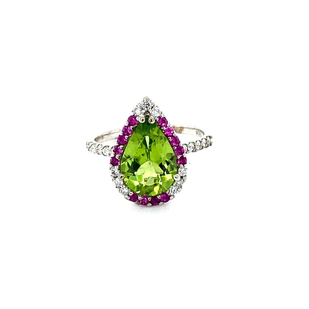Peridot Diamond and Pink Sapphire White Gold Cocktail Ring

This beautiful ring has a Pear Cut Peridot in the center that weighs 2.77 carats. The ring is surrounded by a cute halo of alternating diamonds and pink sapphires. There are 21 Round Cut
