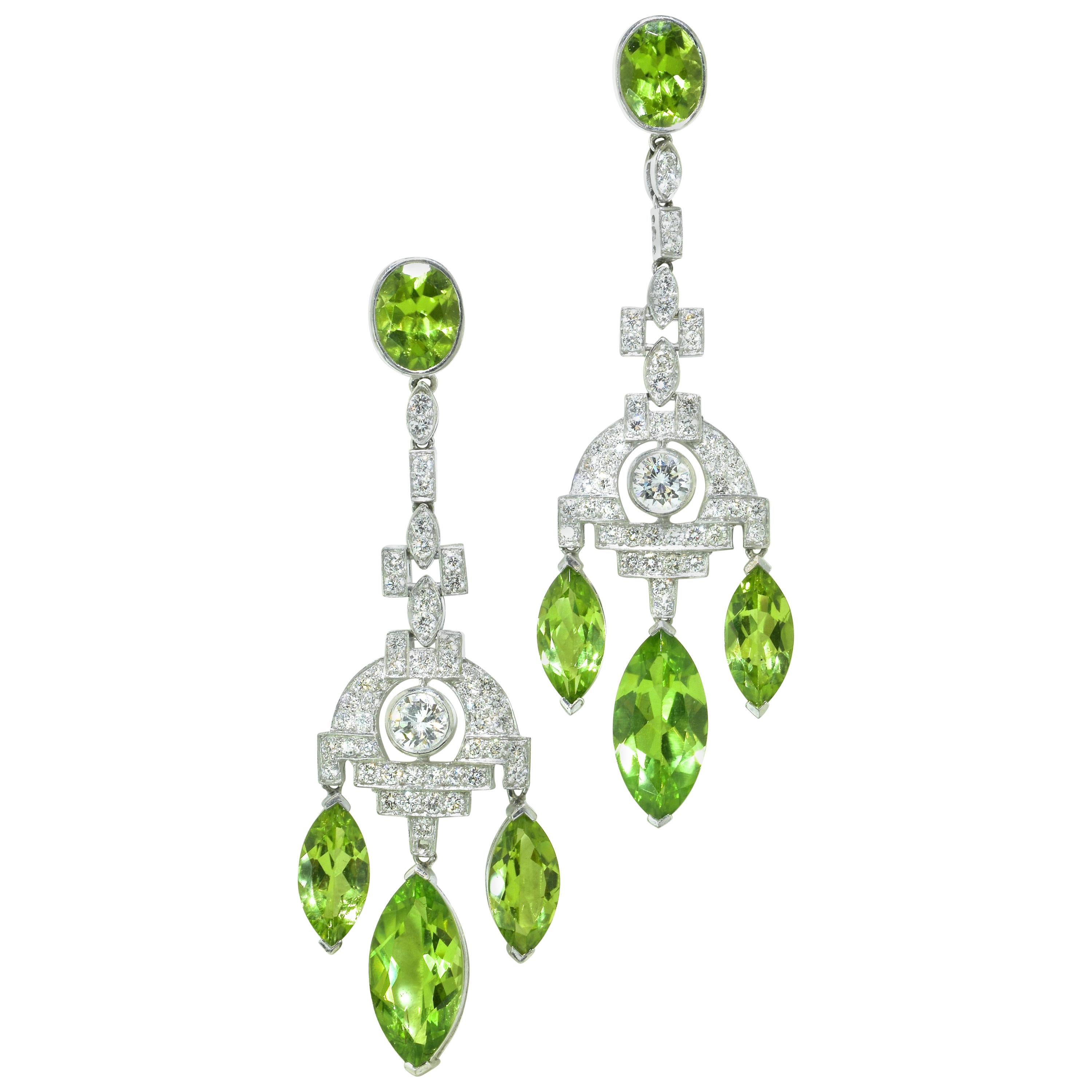  Earrings in platinum possessing 20 cts., of natural fine bright green peridot with 3 cts of near colorless, very slightly included, well matched diamonds, (H), near colorless and very slightly included (VS1).  These earrings are 2.5/6 inches long. 