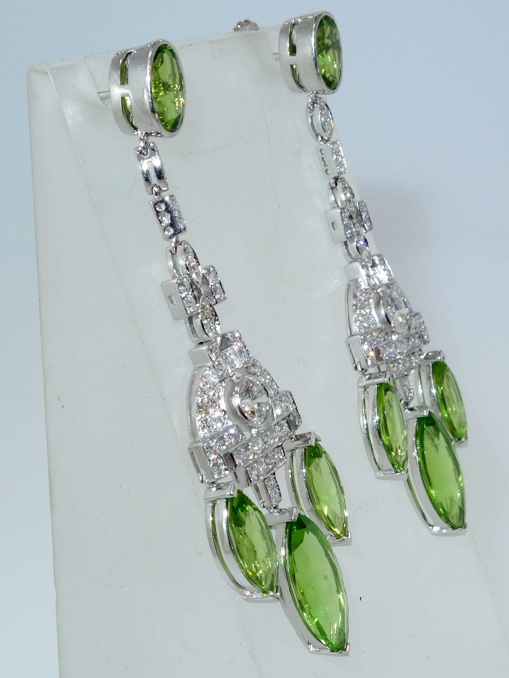 Chandelier Earrings in platinum possessing 20 cts., of natural fine bright green peridot with 3 cts of near colorless, very slightly included, well matched diamonds, (H), near colorless and very slightly included (VS1).  These earrings are 2.5/6