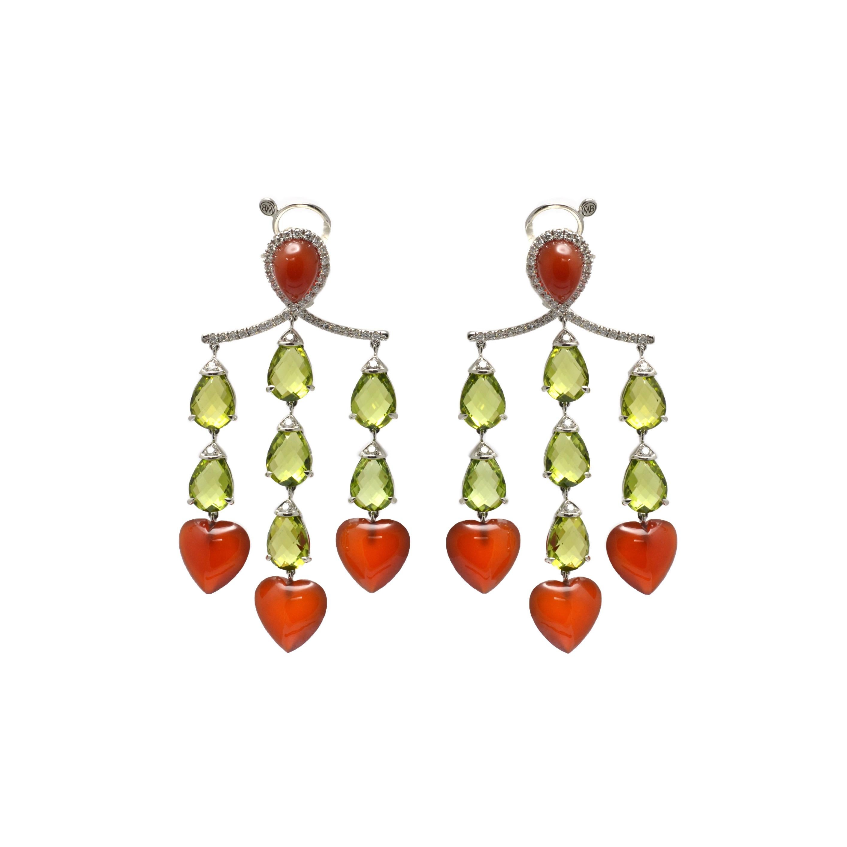 Handcrafted in Italy, in Margherita Burgener family workshop, the stunning  chandelier pendant earrings feature 14  beautiful peridots, briolette cut. On top of each drop there is a little diamond set in white gold.
3 carnelian heart shape cabochon