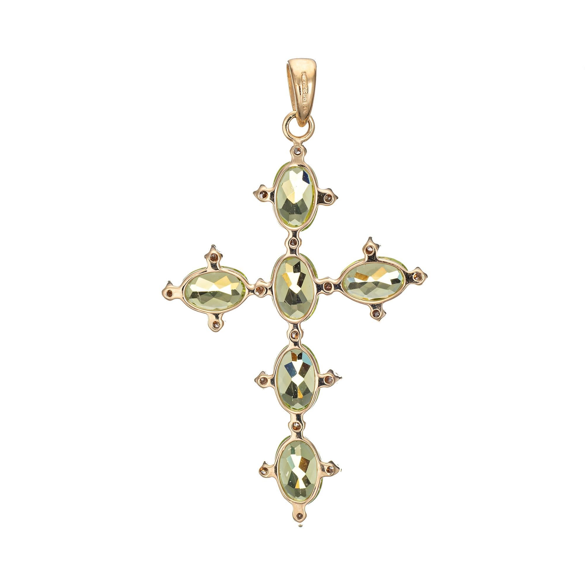 Finely detailed peridot & diamond cross pendant crafted in 14k yellow gold. 

6 oval faceted peridot measures 6mm x 4mm (estimated at 0.50 carats each - 3 carats total estimated weight), accented with an estimated 0.09 carats of diamonds (estimated