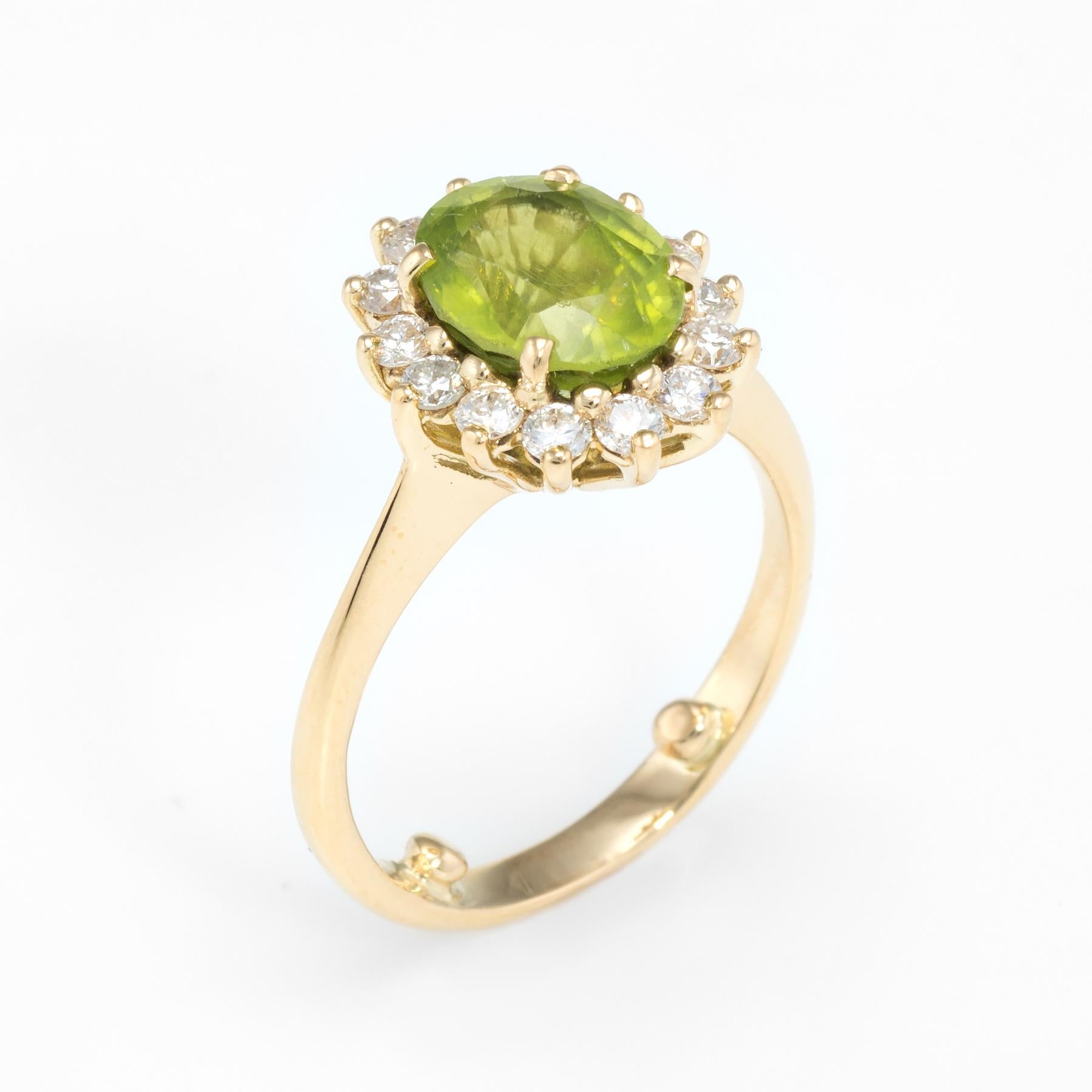 Elegant vintage cocktail ring, crafted in 18 karat yellow gold. 

Faceted oval cut peridot measures 9mm x 7mm (estimated at 2 carats), accented with an estimated 0.50 carats of diamonds (estimated at H color and VS2 clarity). The peridot is in