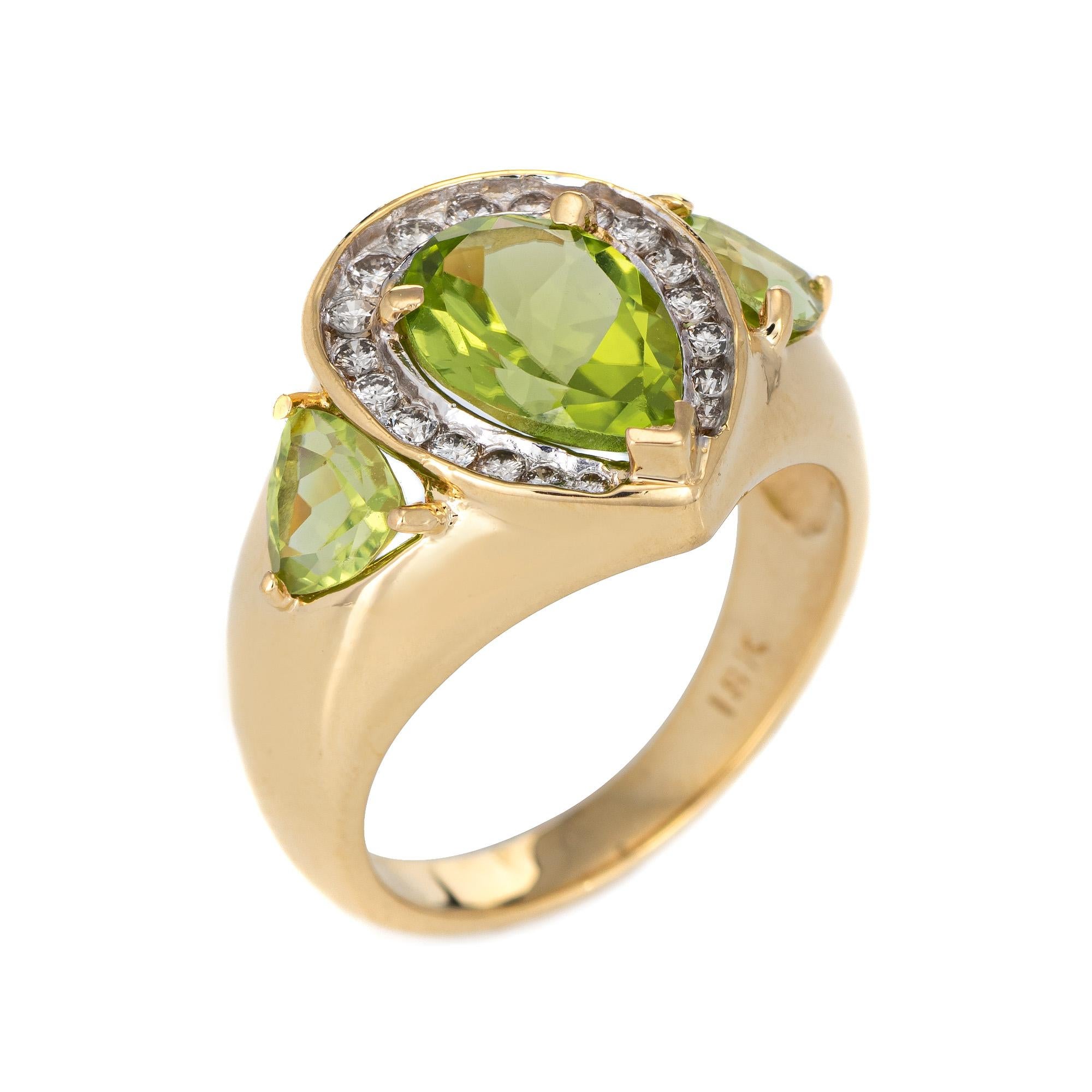 Stylish vintage peridot & diamond (circa 1980s to 1990s) crafted in 18 karat yellow gold. 

Faceted pear cut peridot measures 10mm x 7mm, accented with a further two pieces of peridot (side shoulders) measuring 5mm x 2mm. The total peridot weight is