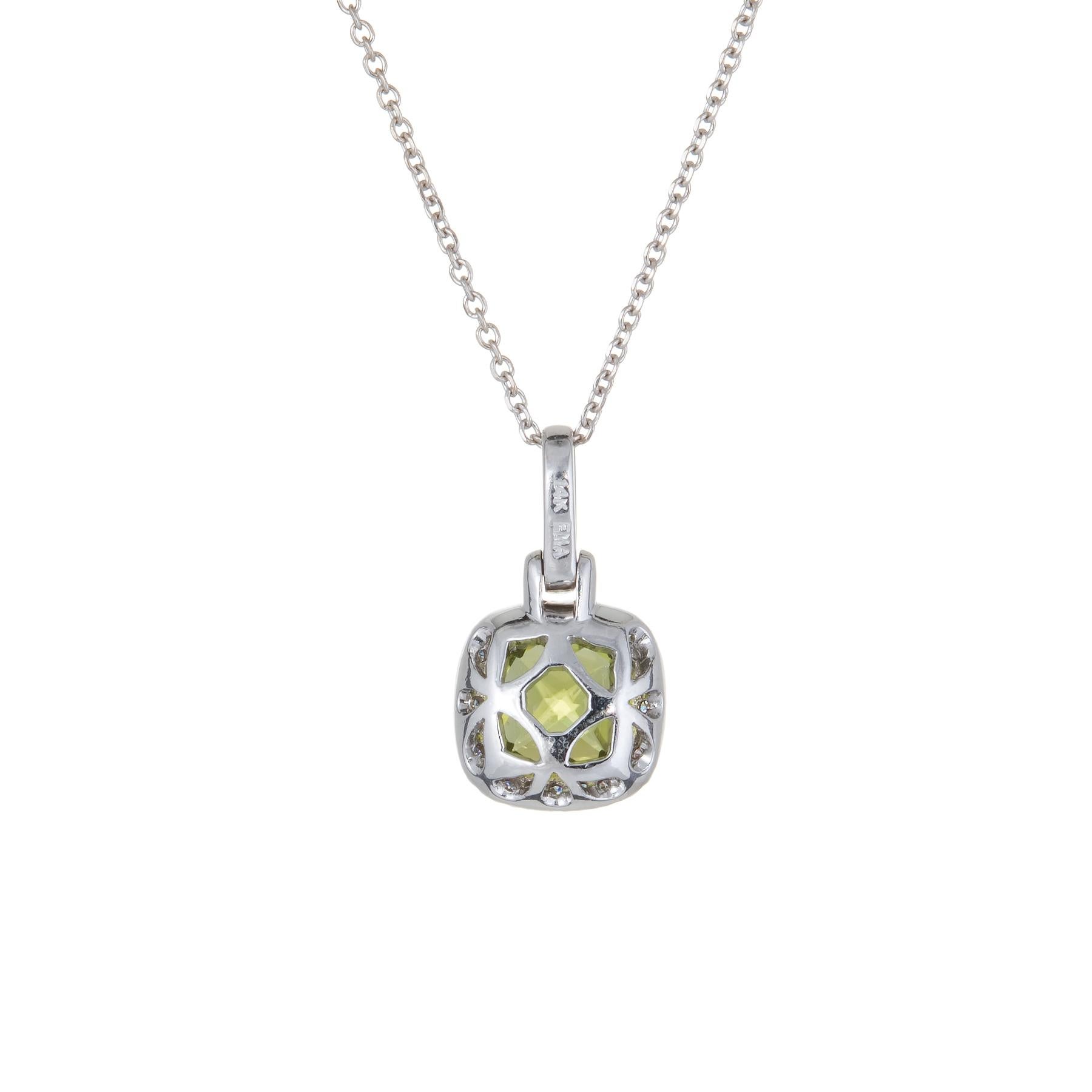 Finely detailed peridot & diamond necklace, crafted in 14 karat white gold.  

Checkerboard faceted peridot measures 7mm (estimated at 2 carats), accented with an estimated 0.12 carats of diamonds (estimated at G-H color and VS2 clarity). 

The