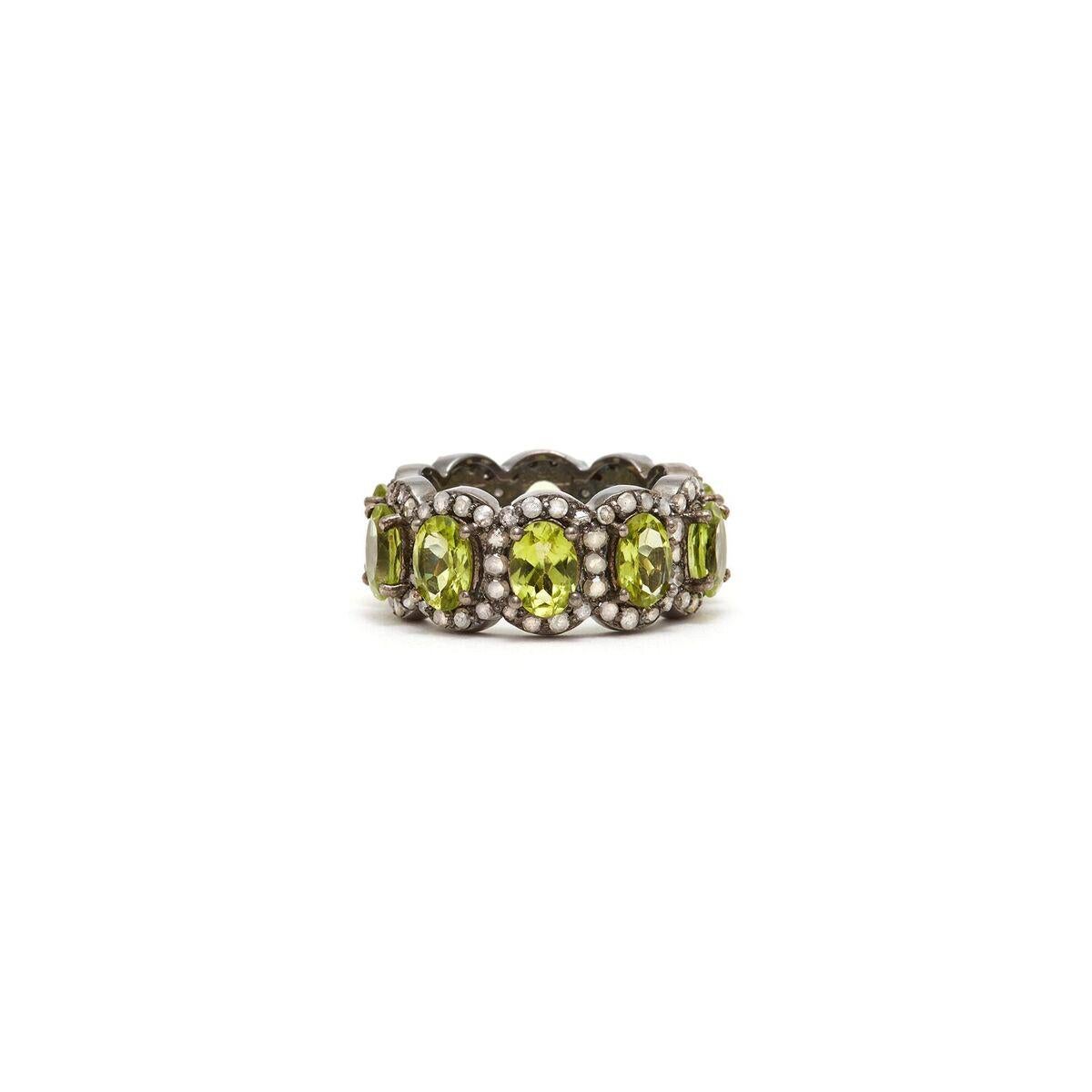 Alluring baguettes of green Peridot accented with white Diamonds in a band of blackened silver reminiscent of an Art Deco Tiara.

- Natural Green Peridot.
- White Diamonds.
- Set in Blackened Oxidized Silver.