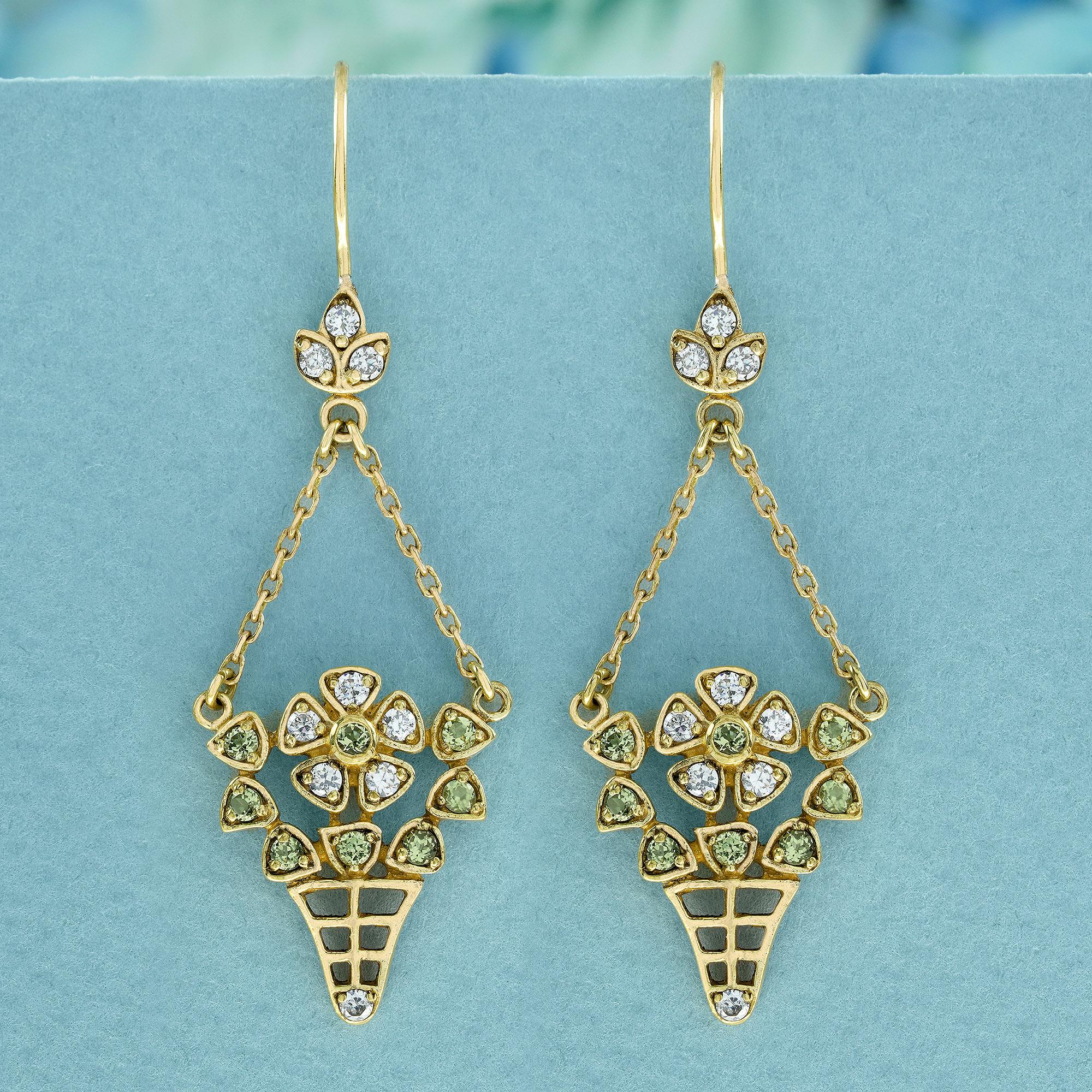 These vintage-style floral basket drop earrings, meticulously crafted from delicate yellow gold. The enchanting design features a basket suspended from a cluster of small diamonds within a leaf-shaped frame at the top. Within the basket, a