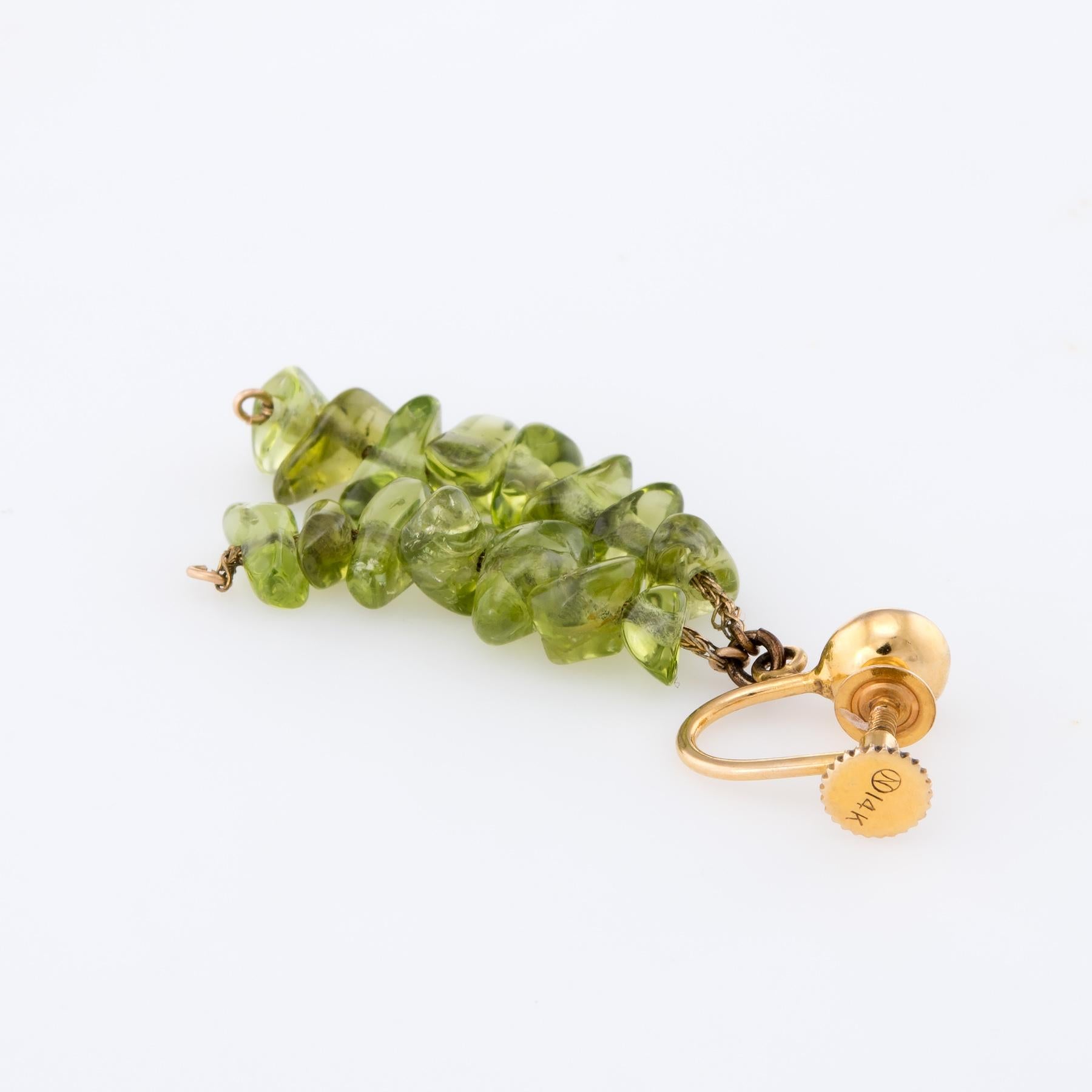 Elegant pair of vintage peridot drop earrings, crafted in 14k yellow gold. 

Freeform natural peridot is polished smooth. The peridot ranges in size from 8mm x 4mm (average).  

The earrings feature screw backings.

The earrings are in excellent
