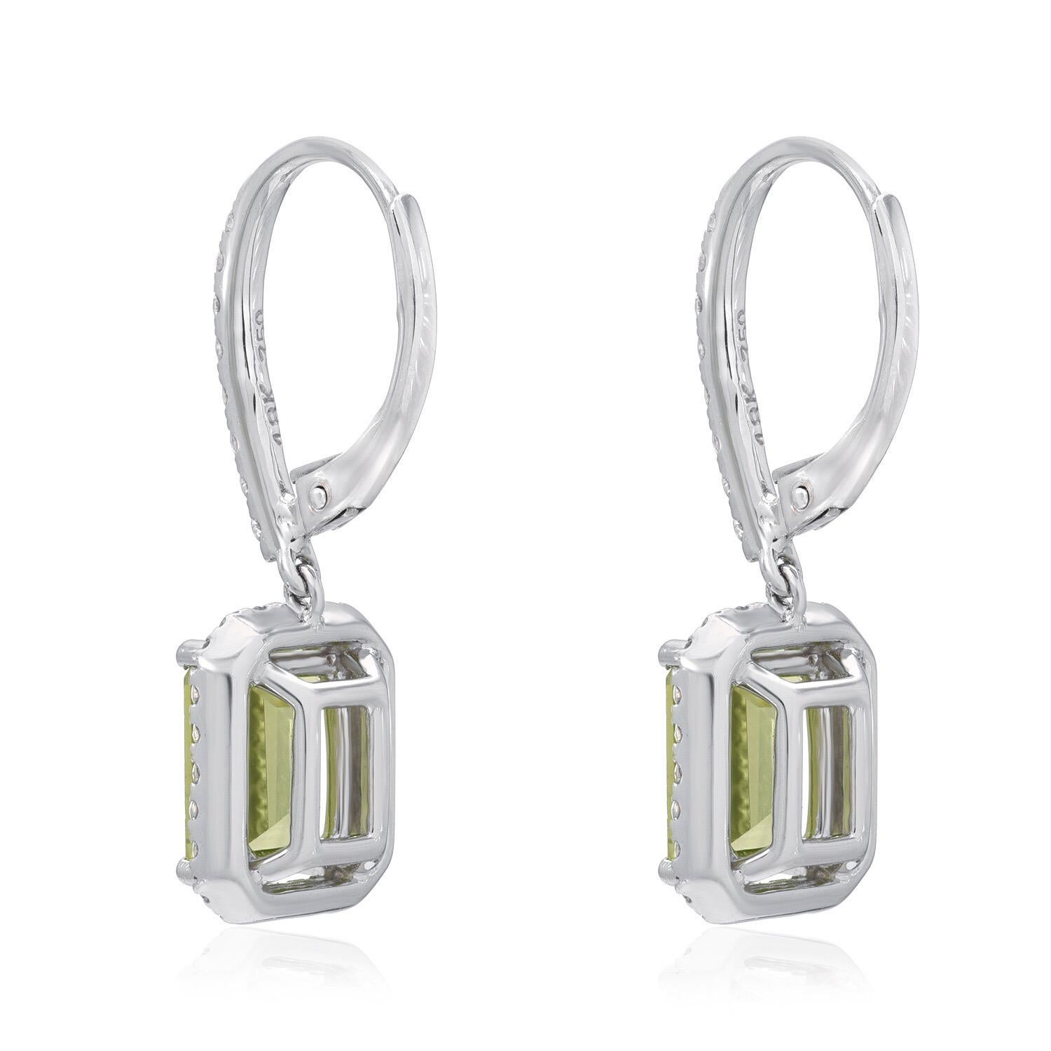 Peridot emerald cut pair, weighing a total of 3.20 carats, are adorned by a total of 0.52 carat round brilliant diamonds, in these drop lever back 18K white gold earrings for women.
Approximately 1 inch in length.
Returns are accepted and paid by us