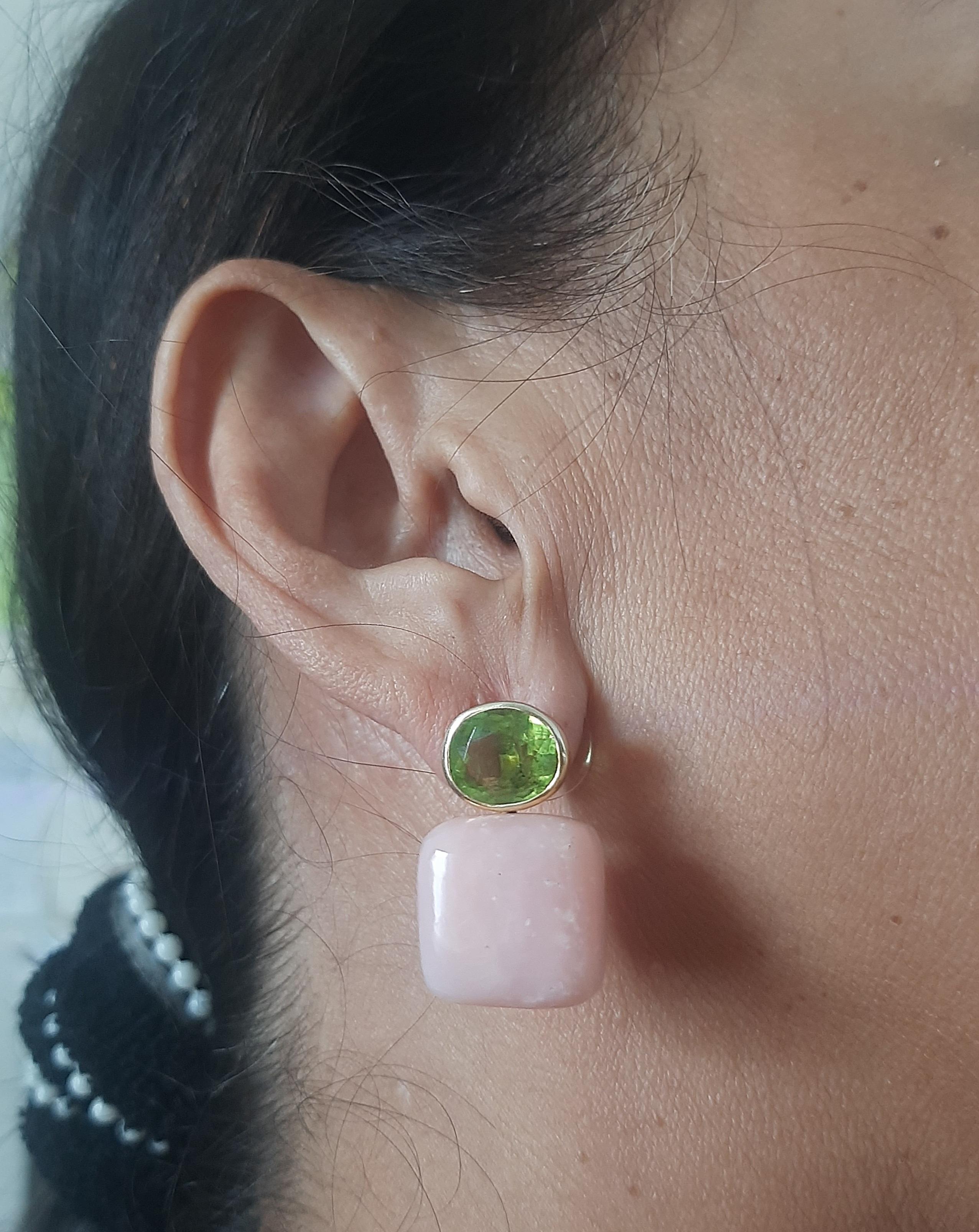 Diese schlichten, aber eleganten und handgefertigten Ohrringe bestehen aus 2 ovalen, facettierten Peridots mit den Maßen 8 x 10 mm, die in eine Lünette aus 14-karätigem Gelbgold eingefasst sind, an der 2 kissenförmige, echte rosa Opale mit den Maßen