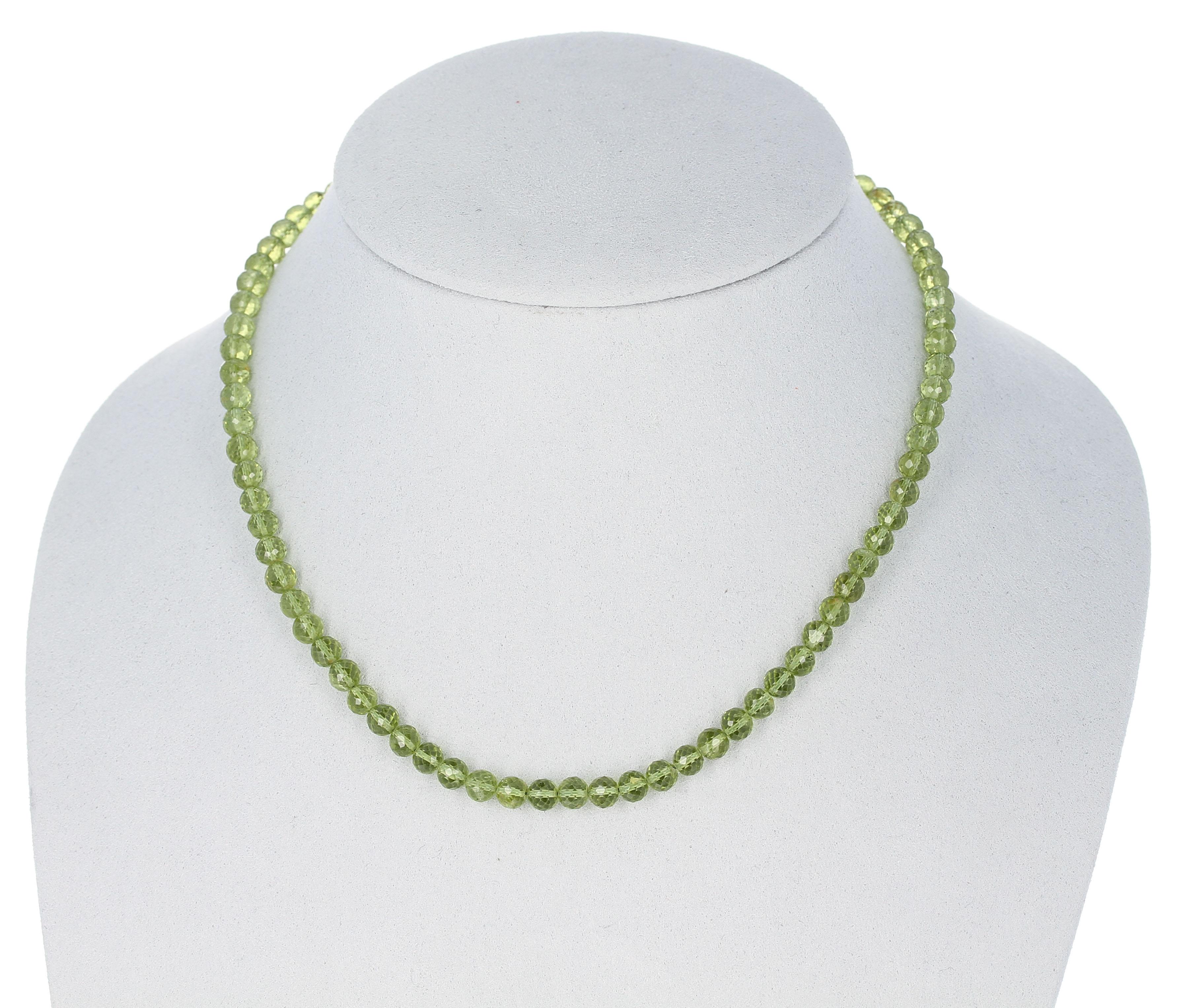 A strand of Peridot Faceted Round Beads Necklace with a Sterling Silver Toggle Clasp. Length: 17.5