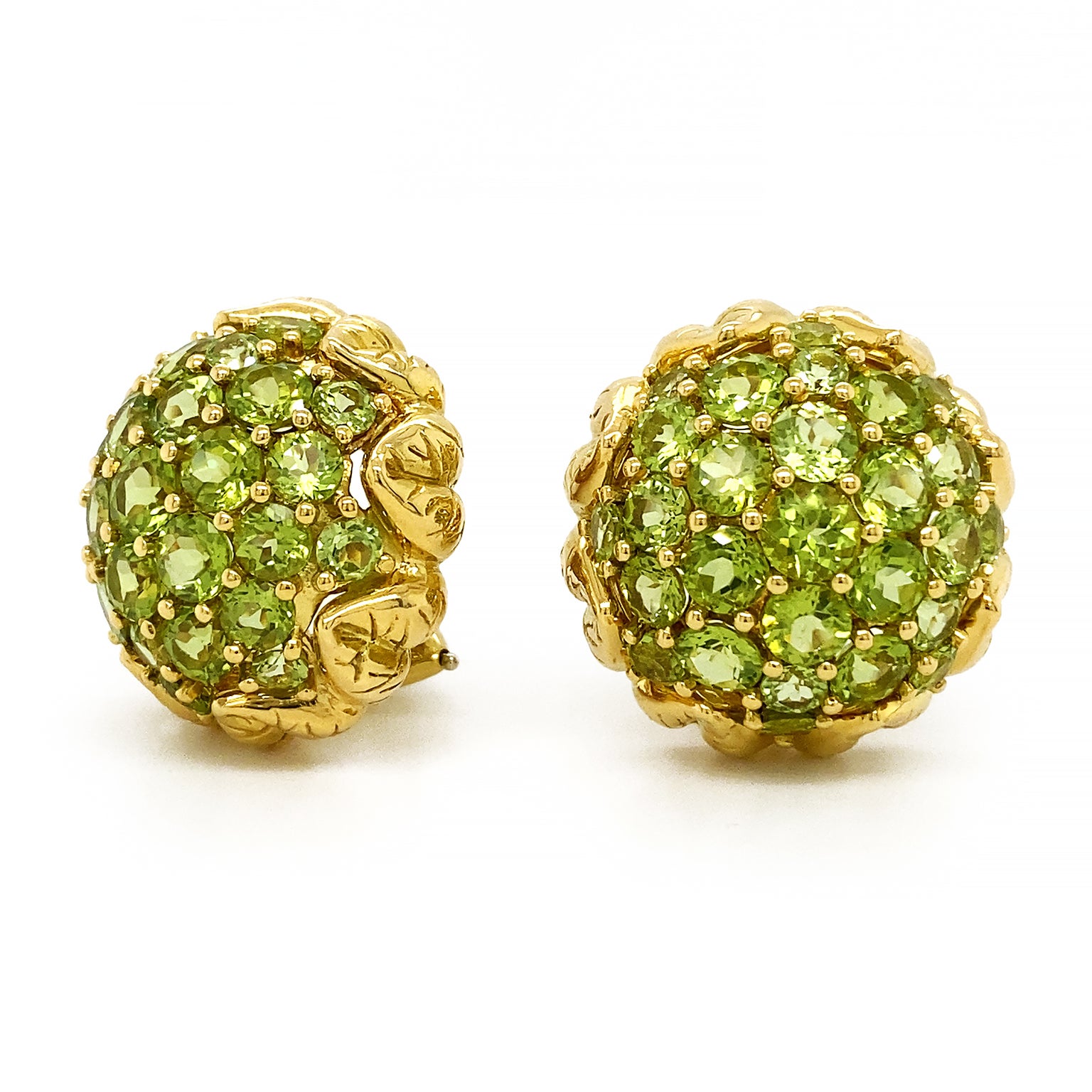 Jewels and gold illustrate a flower bud soon to blossom. The heart of these earrings is a cluster of pave set peridots glistening in every direction as the light falls upon them. 18k yellow gold furnishes textured petals surrounding the jewels,