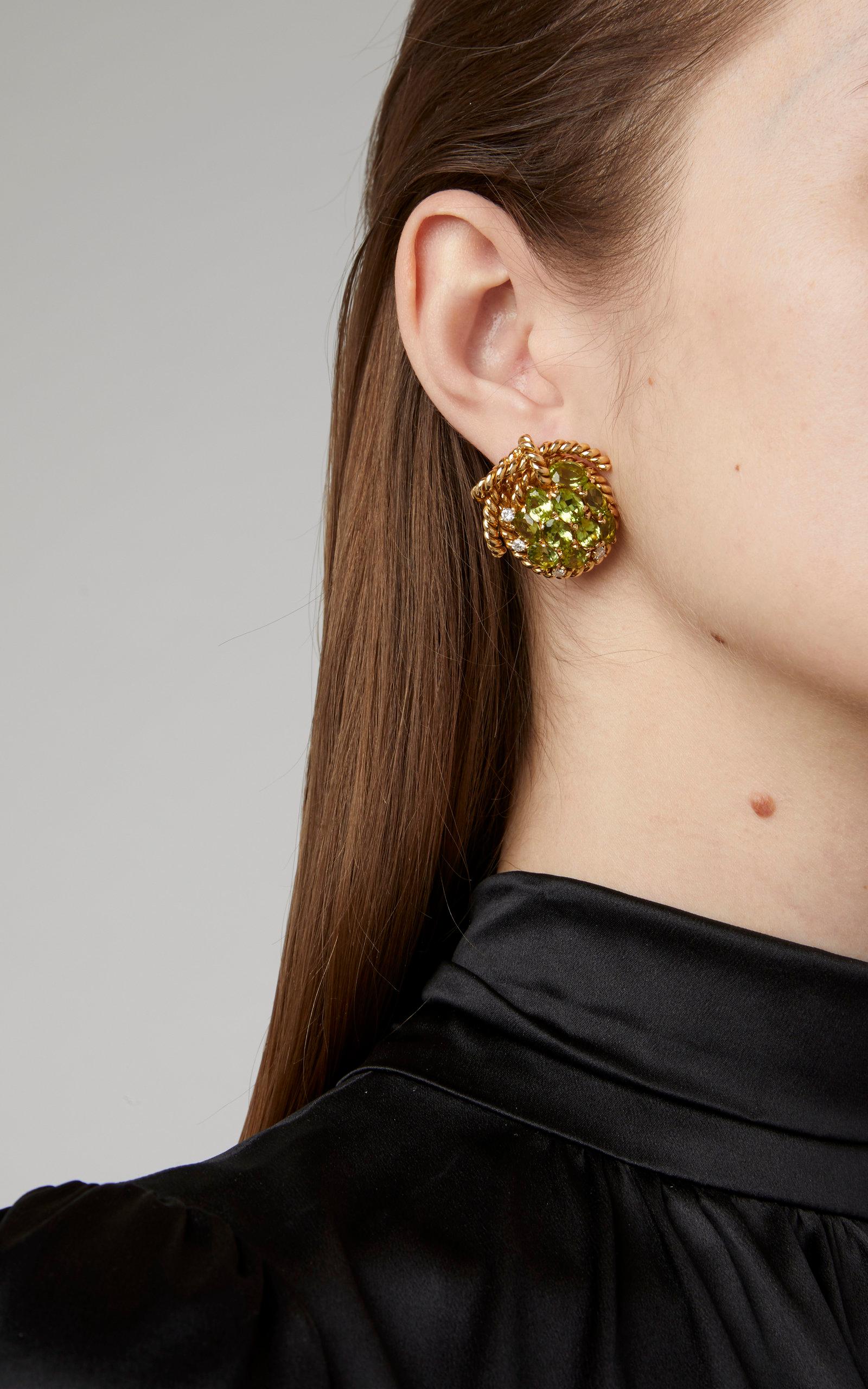 A pair of peridot and 18kt yellow gold ear-clips resembling grapes. Circa 1970

