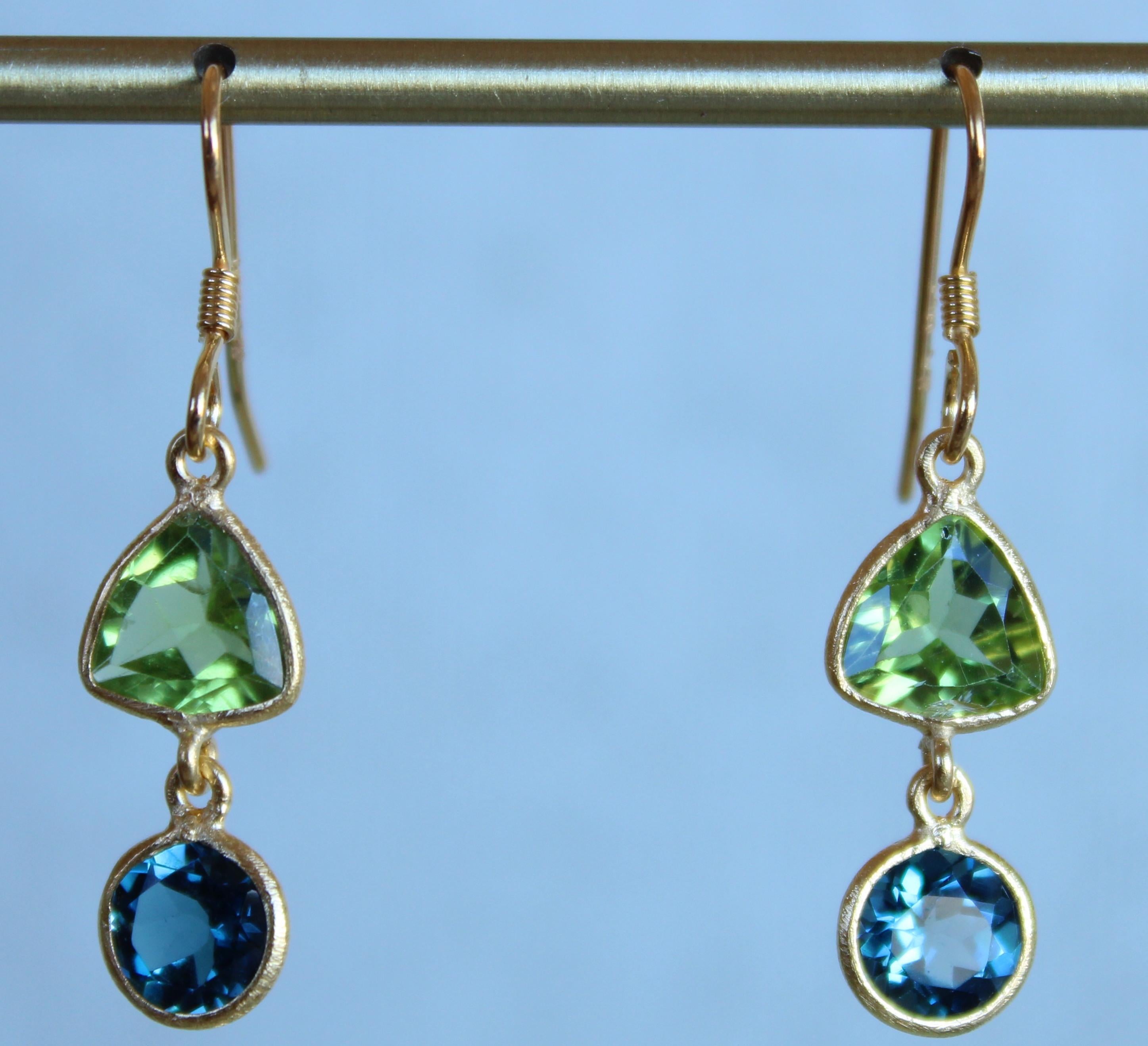 Bursting with sparkle and colour, these new Oiseau Bleu dangle earrings are comprised of nearly 2 carats of green trillion Peridot set above two round London Blue Topaz stones. These earrings are designed to be worn either as a pair or as a single