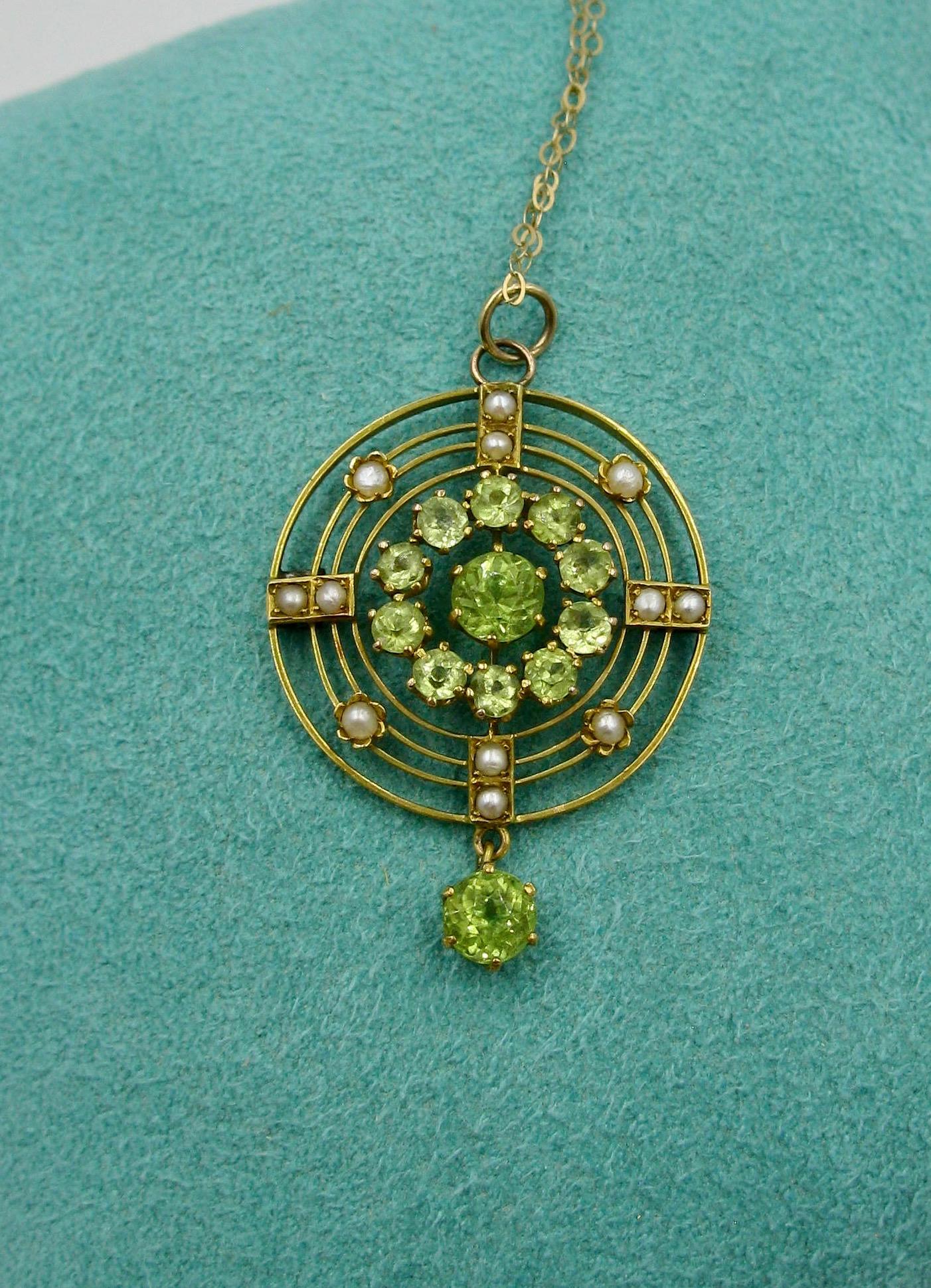 A stunning antique Victorian - Edwardian Peridot and Pearl Lavaliere Pendant Necklace.  The gorgeous pendant in a circular design is set with 12 sparkling round faceted Peridot gems.  The central Peridot is approximately 1/2 Carat.  The wonderful