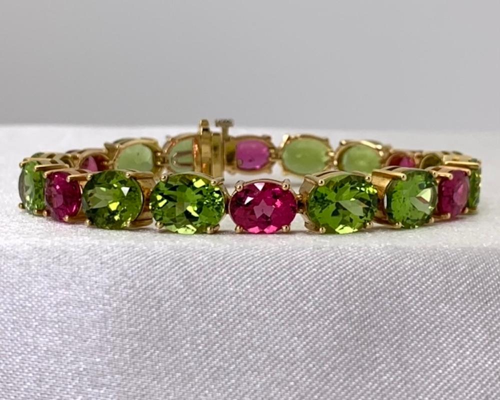 This gorgeous 18k gold tennis bracelet features vivid green peridot paired with bright pink tourmaline - a truly stunning combination! With exactly 42 carats of the finest quality gemstones, this is definitely 