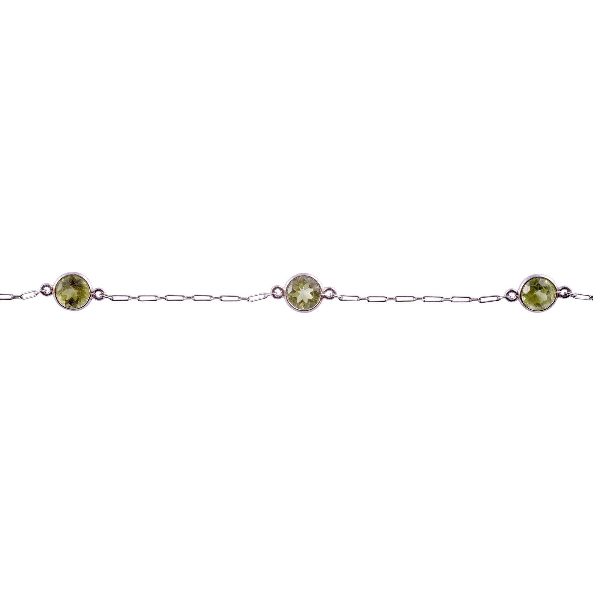 Estate peridot platinum necklace. This platinum necklace features 11 bezel set 5.55mm round peridot at approximately 8.50 carat total weight. The peridot have a vibrant yellow green color. [KIMH 2901 P]
 
Dimensions
 
18.375″L