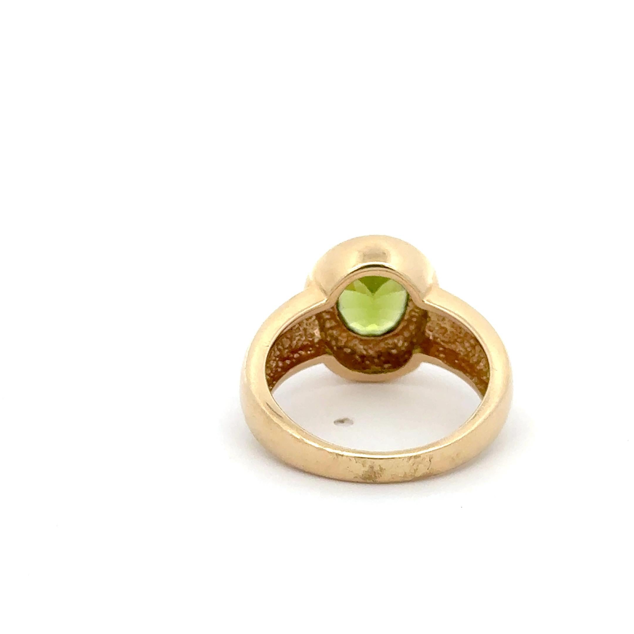 Anello con peridoto in oro giallo 14K. L'anello presenta un peridoto ovale incastonato. L'anello è una misura 7 e pesa 6,2 grammi. 
